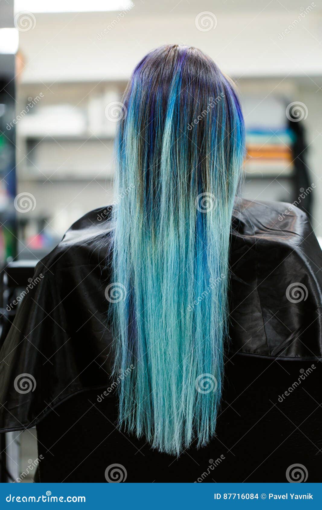 A Girl With Dyed Hair Sitting In A Chair At The Beauty Salon