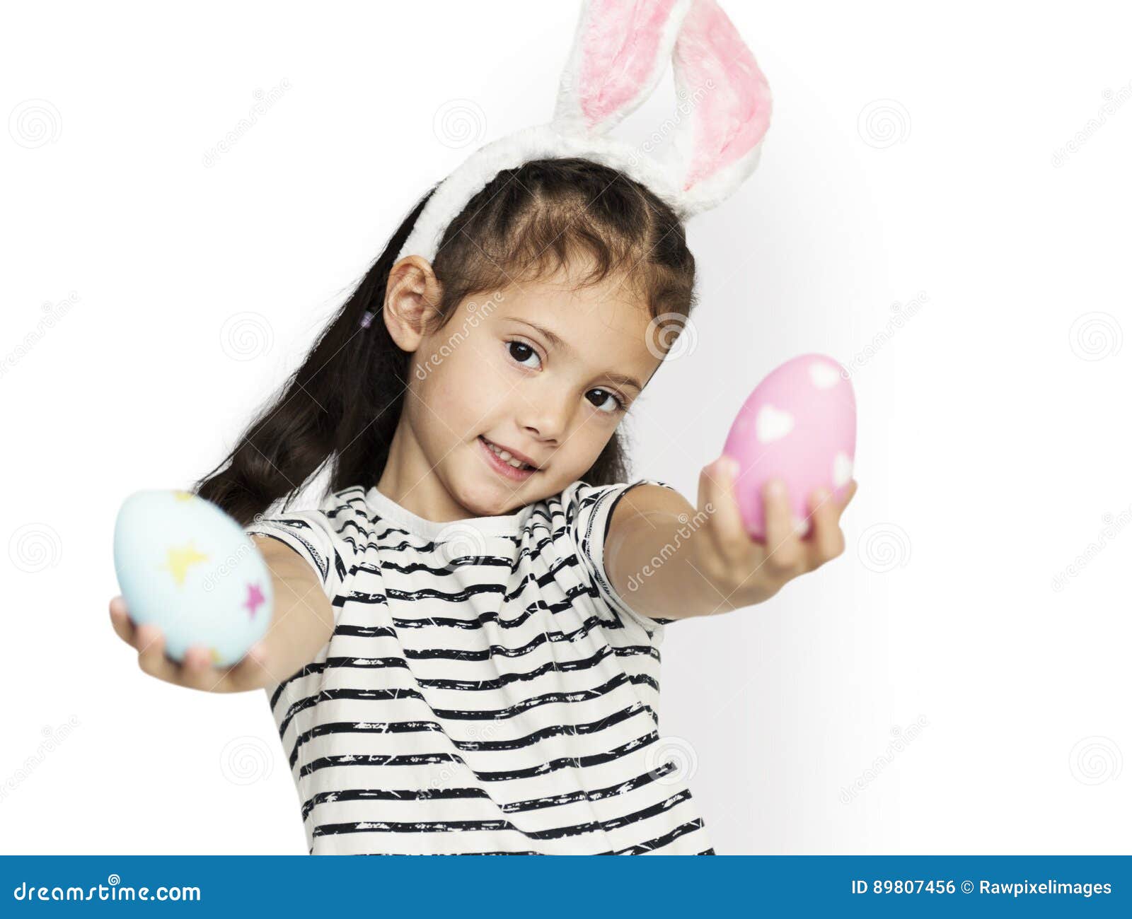 a girl with an easter eggs and bunny hairband
