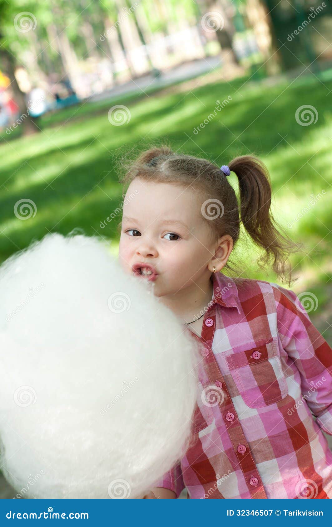 Girl eating cotton candy stock image. Image of happy 32346507