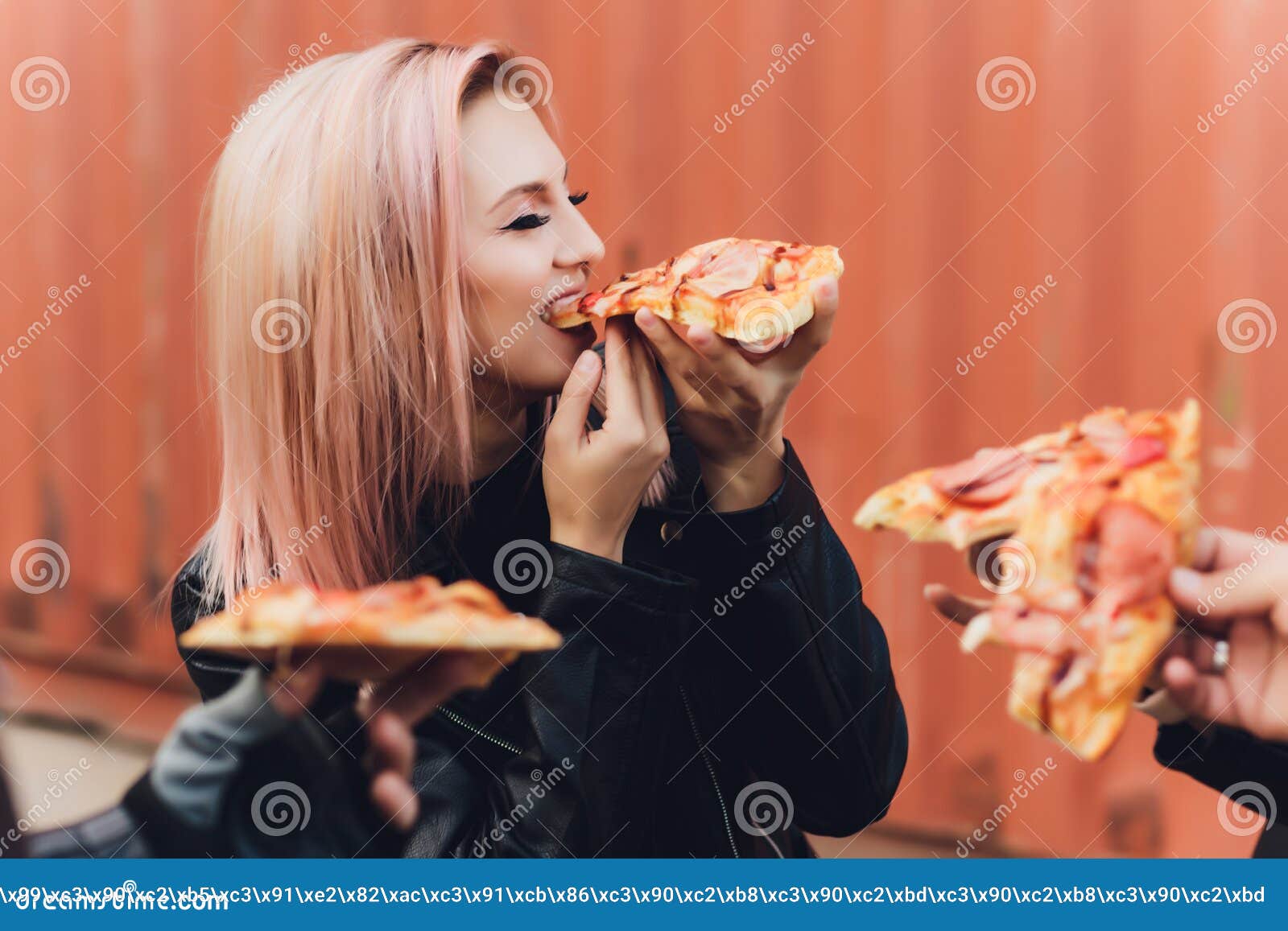 Girl Eating A Delicious Pizza While Sitting On A Motorcycle Stock