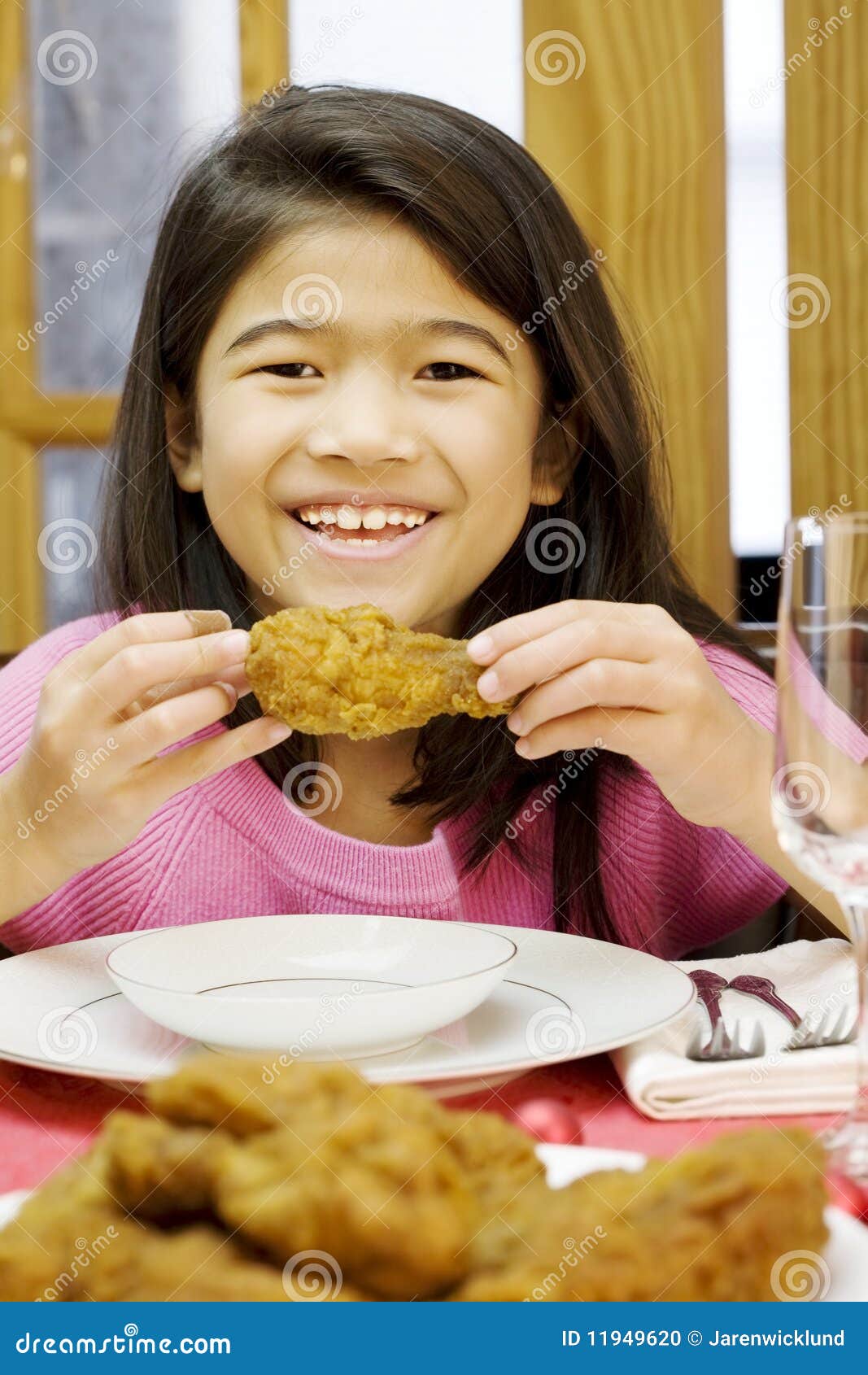 girl eating fried chicken drumstick