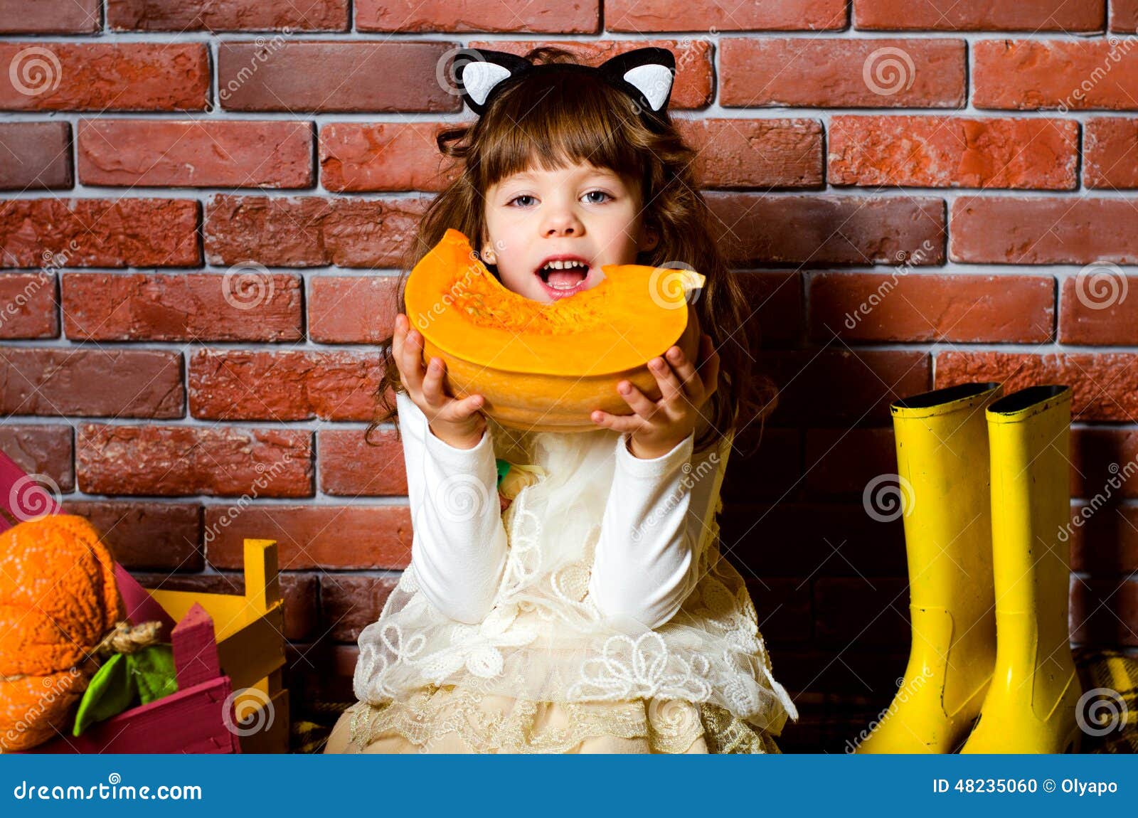 Girl eating a pumpkin stock photo. Image of care, background 48235060