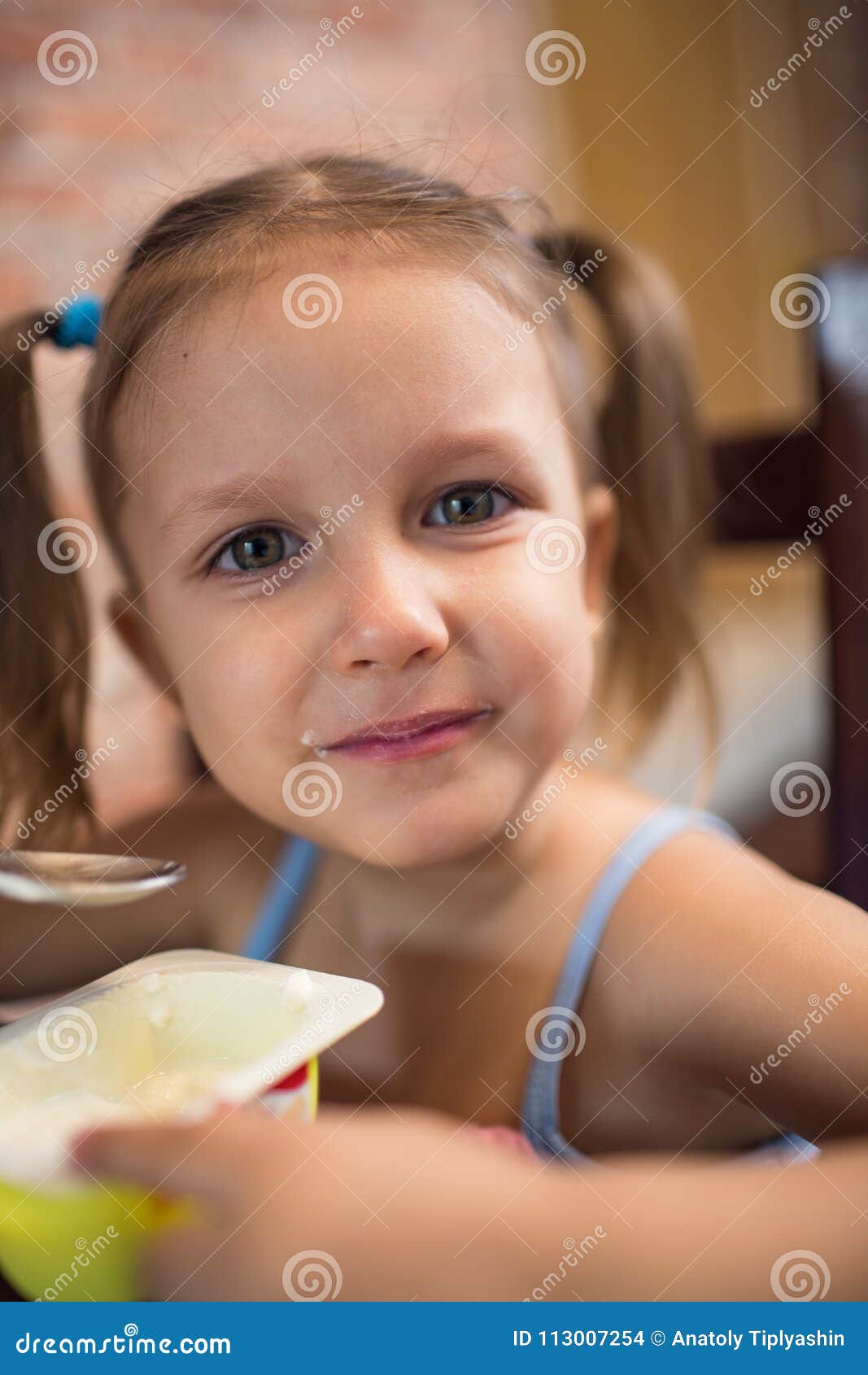 Girl eating yogurt stock photo. Image of childhood, meal 113007254