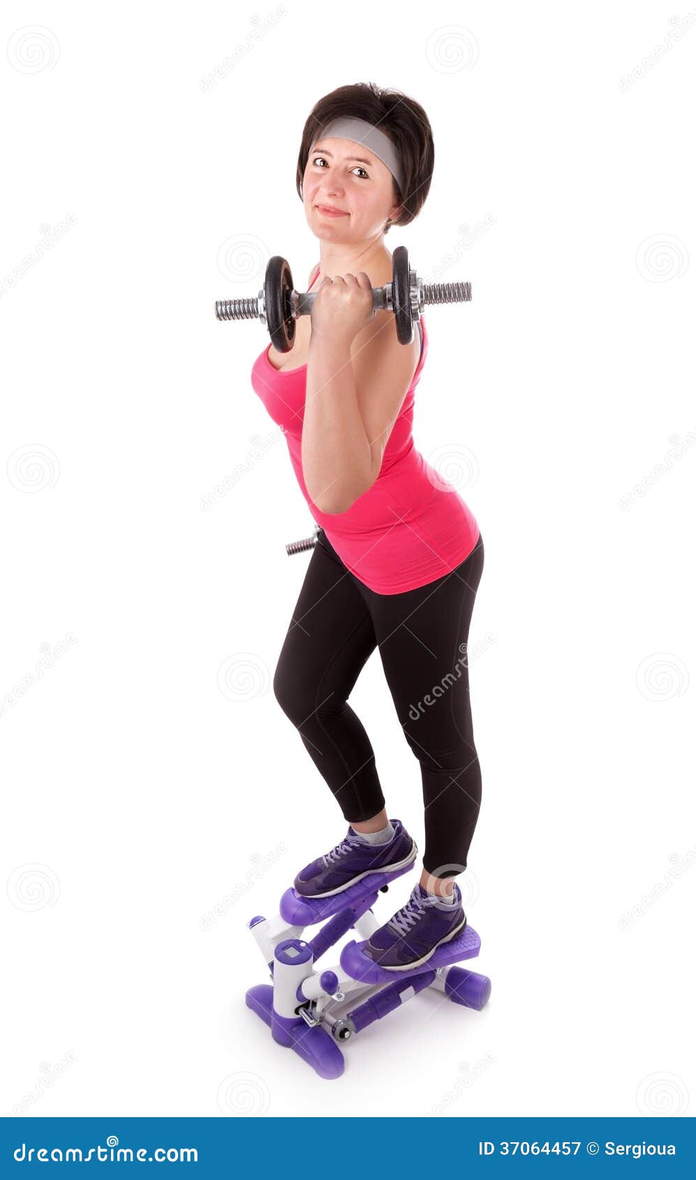 The girl is engaged in fitness with dumbbells on stepper. On a white background.