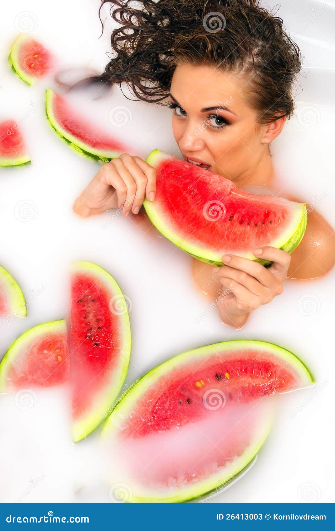 girl enjoys a bath with milk and watermelon.