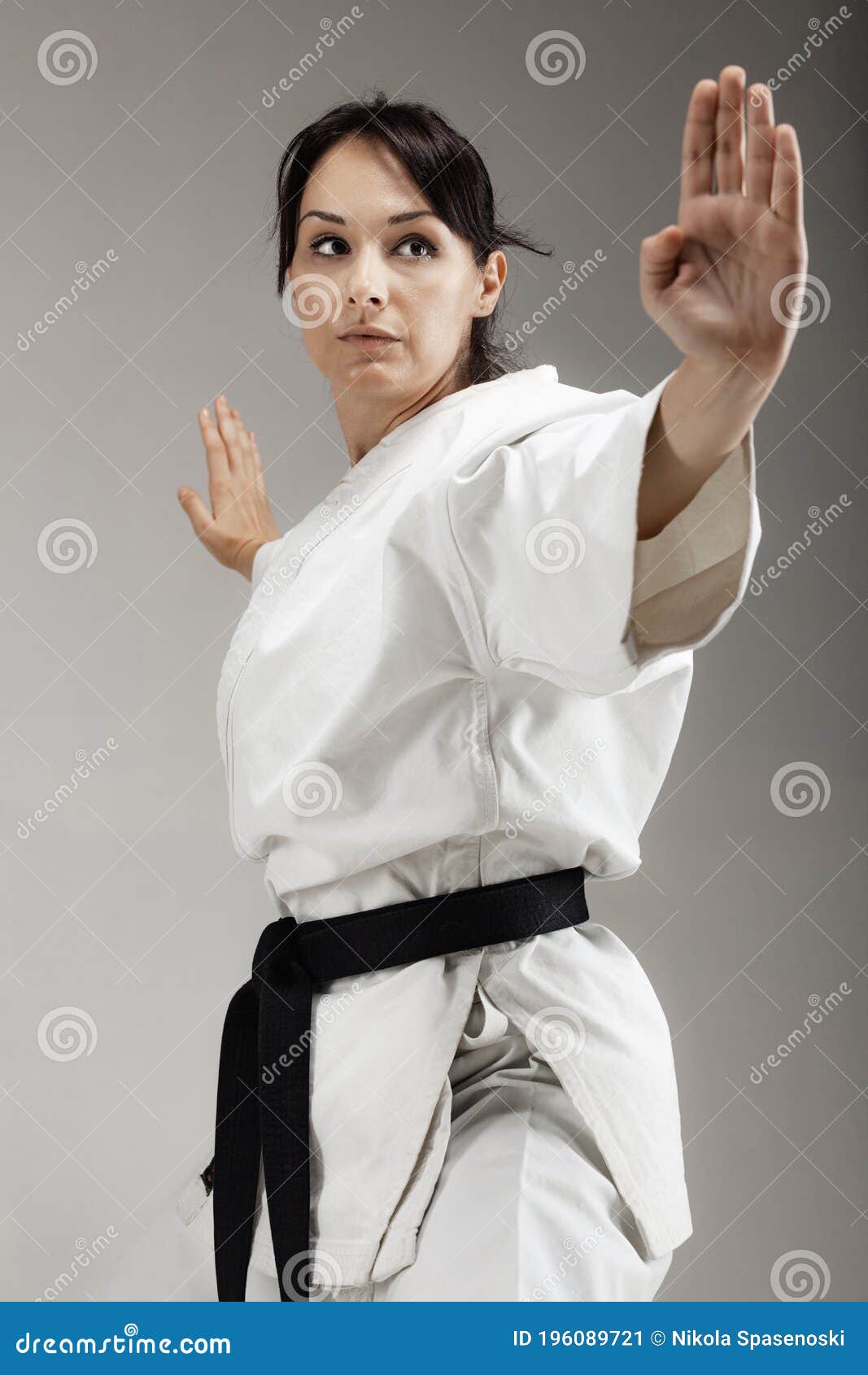 Girl Exercising Karate, Posing Against Gray Background Stock Image ...