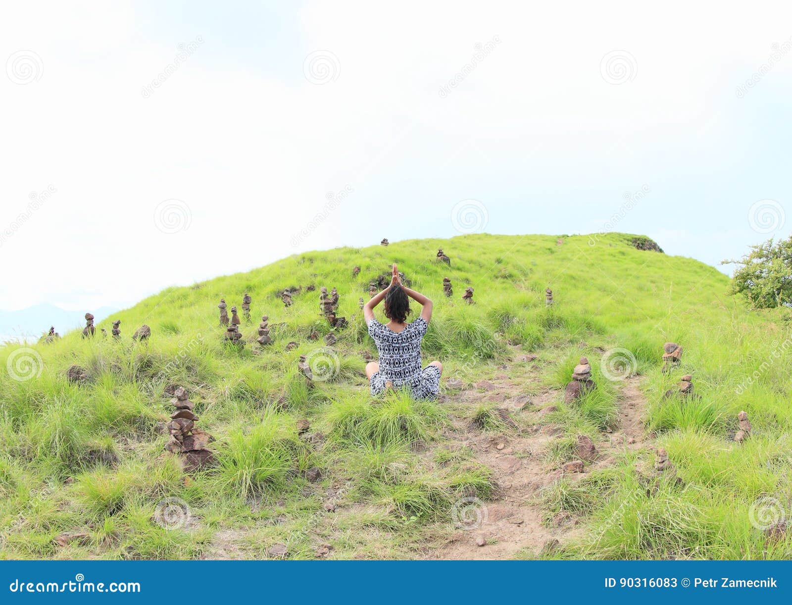 girl exercising yoga among stone stacks on padar island