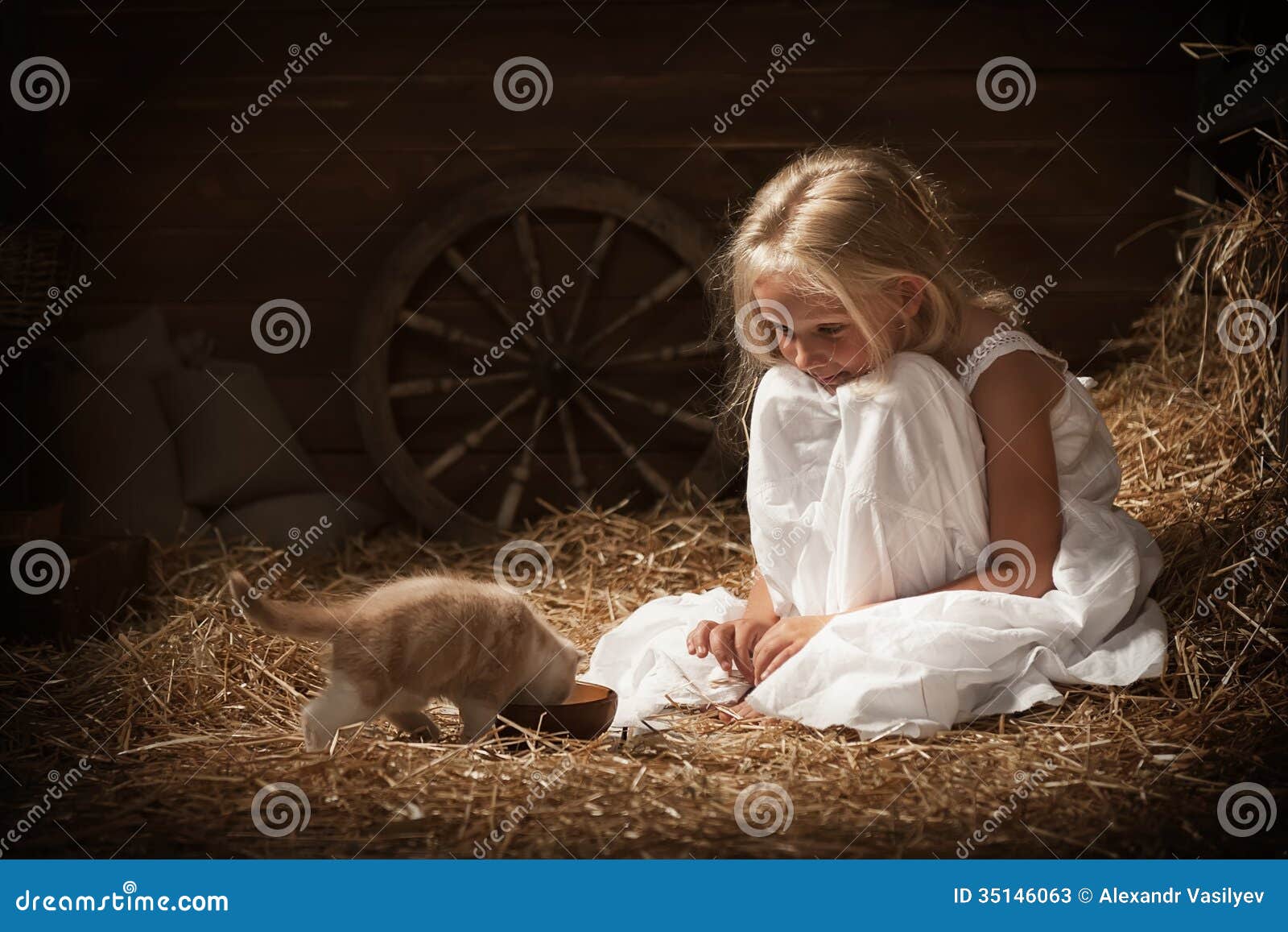 girl feeding a kitten milk