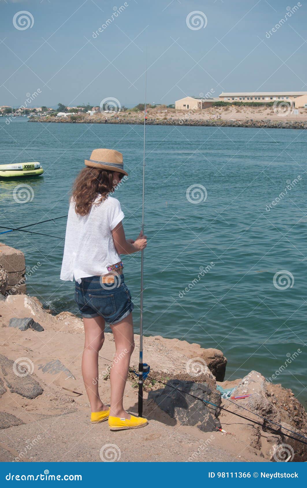 Girl fishing on the beach editorial photo. Image of people - 98111366