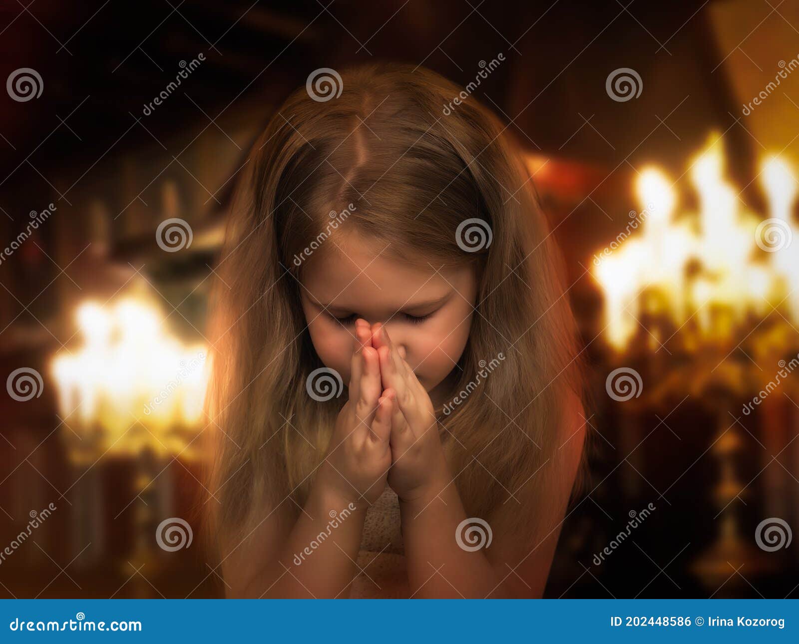 girl folded her hands in a prayerful gesture. child praying in the temple