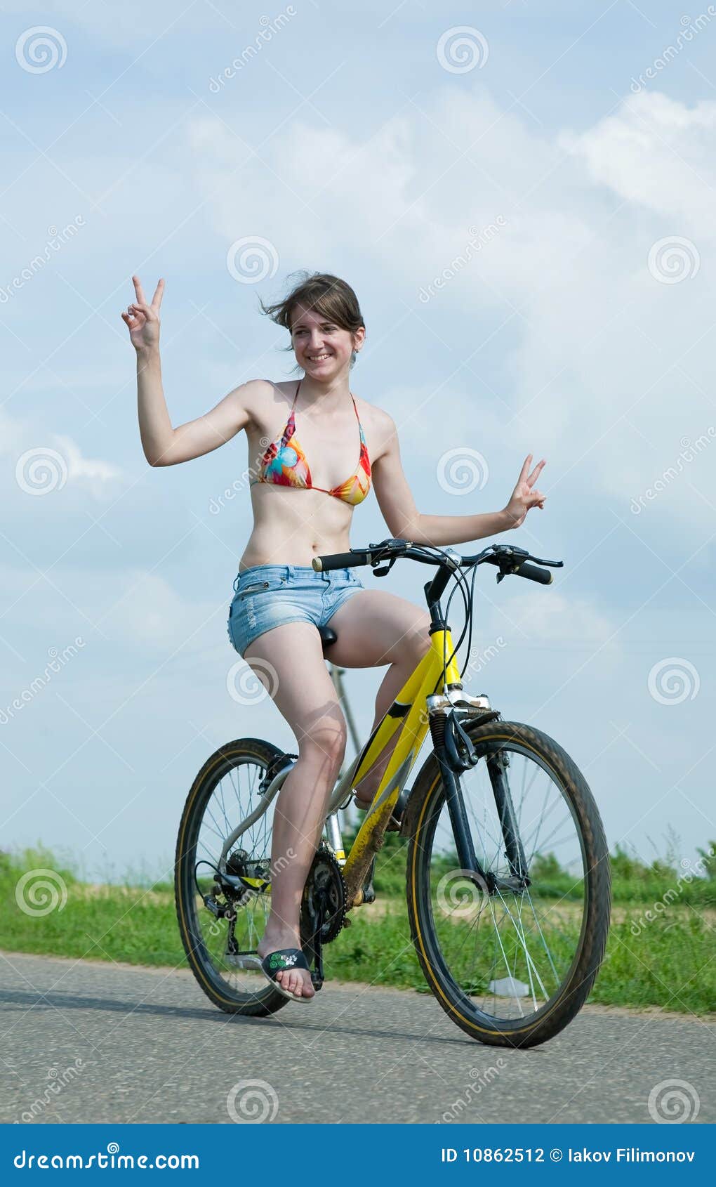 Girl goes on bicycle. Young girl having riding her bicycles