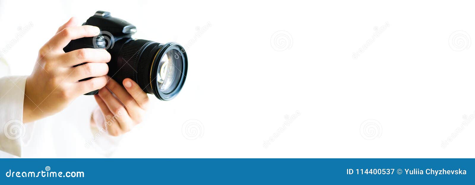 girl hands holding photo camera, white background, copy space. travel and shoot concept. banner