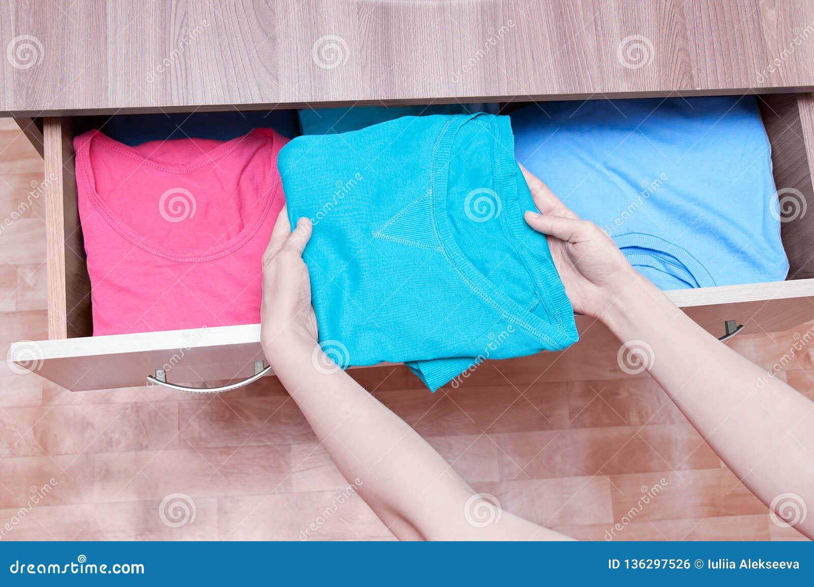 Girl Hands Take Out Clothes From The Dresser Top View Close Up