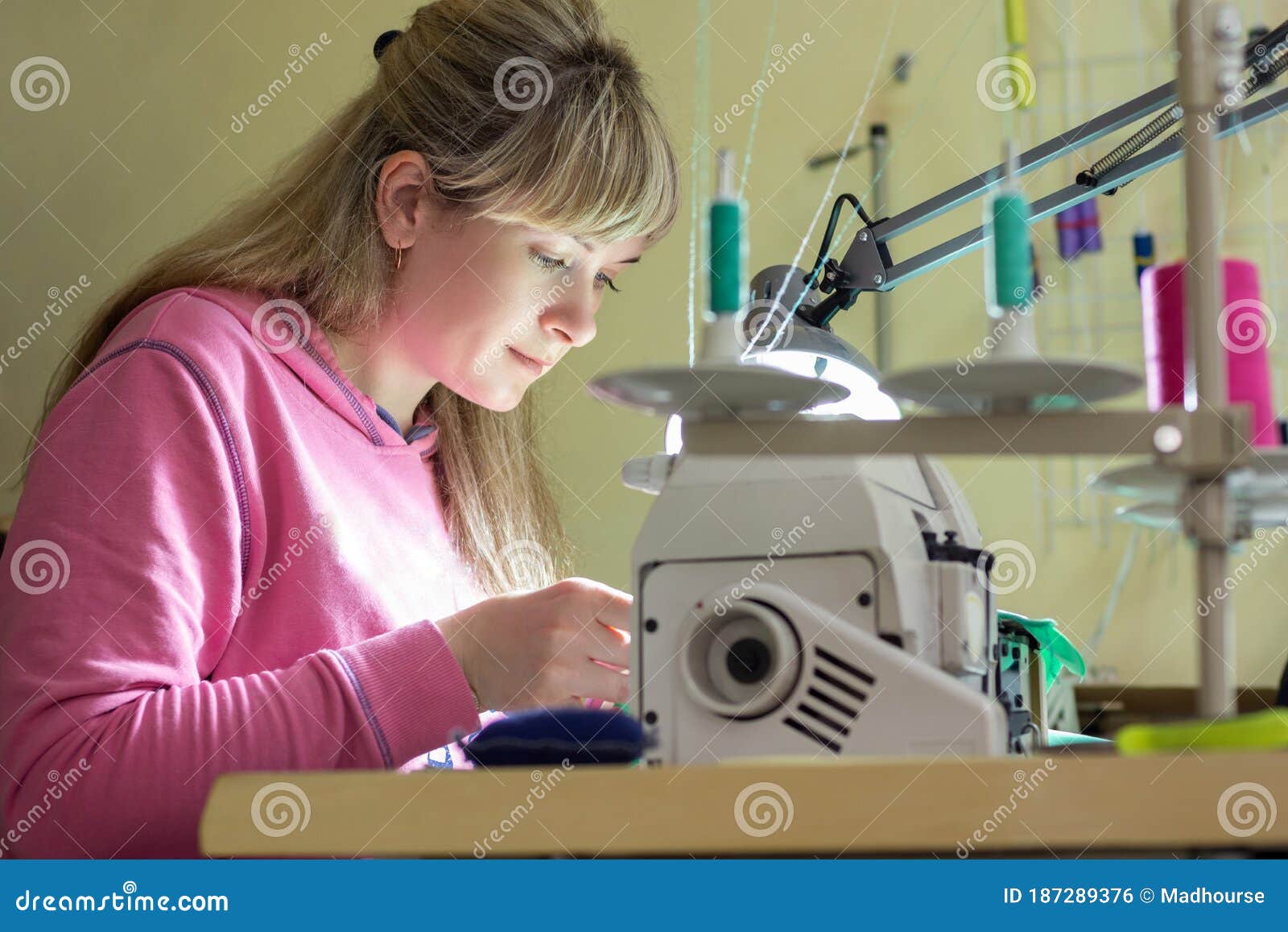Girl Happily Sews on a Professional Sewing Machine Stock Photo Image