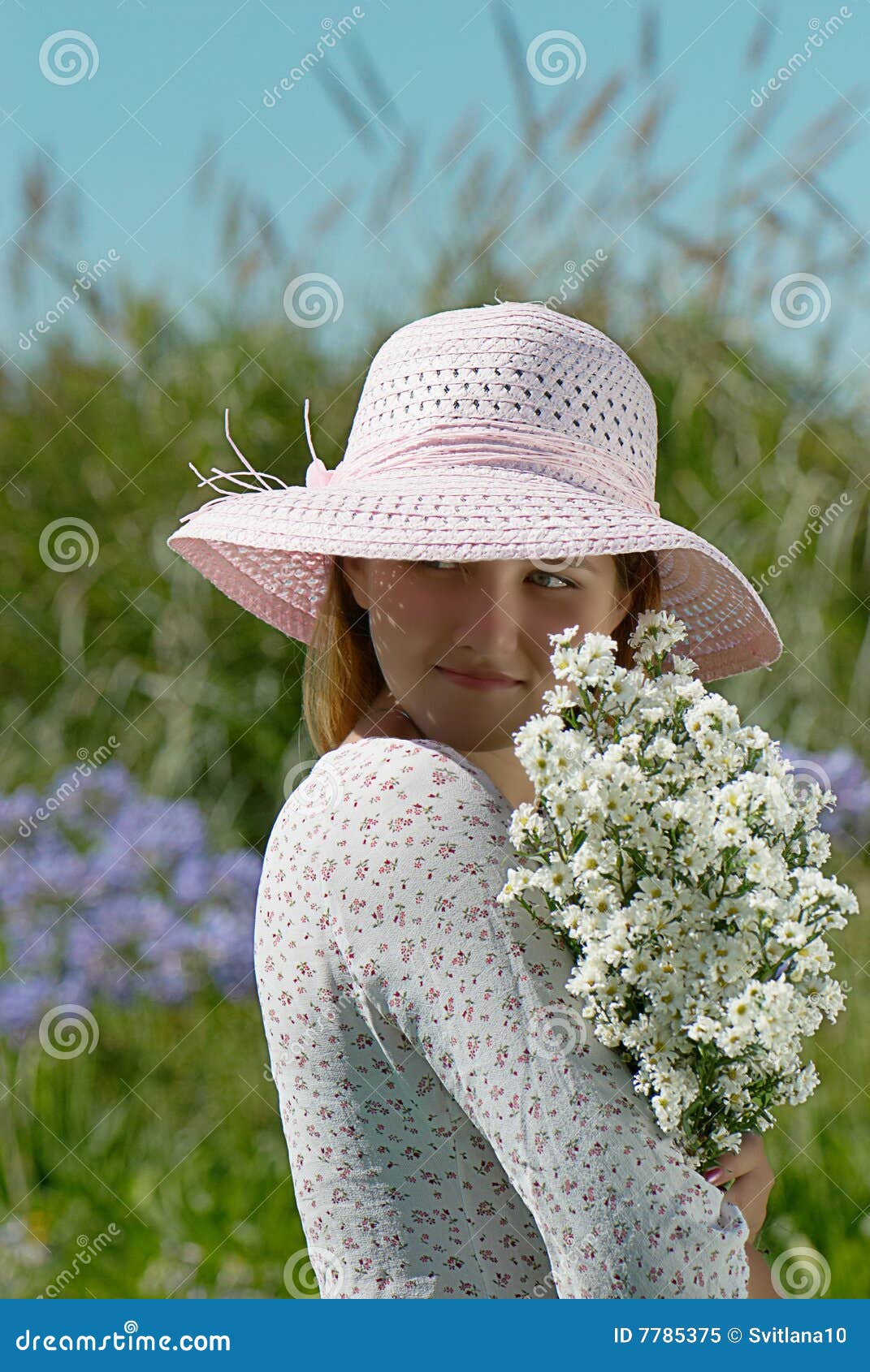 Girl in a hat with flowers stock image. Image of pink 7785375