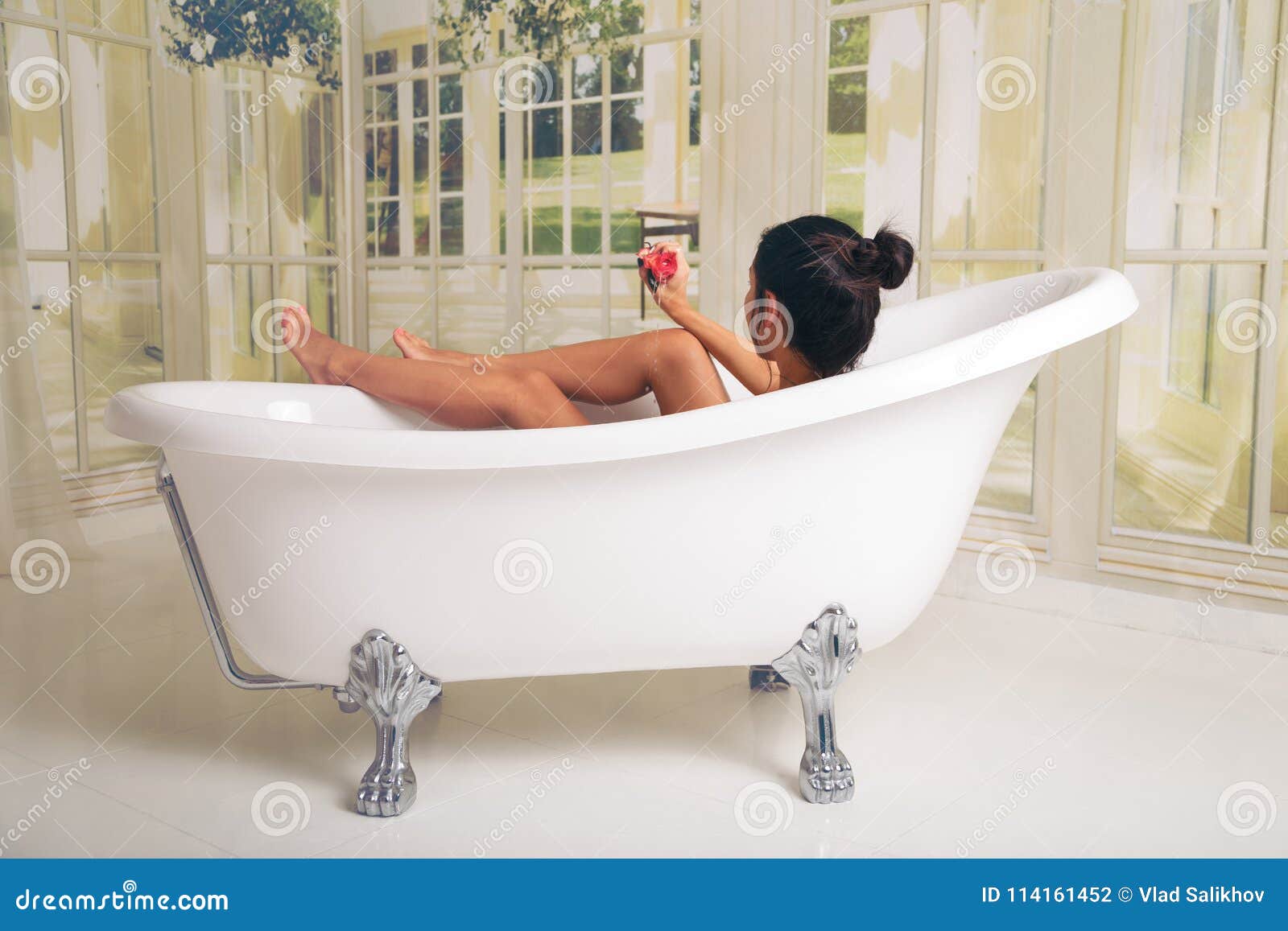 Girl Having Fun In The Tub She Is In A Spacious And Elegant