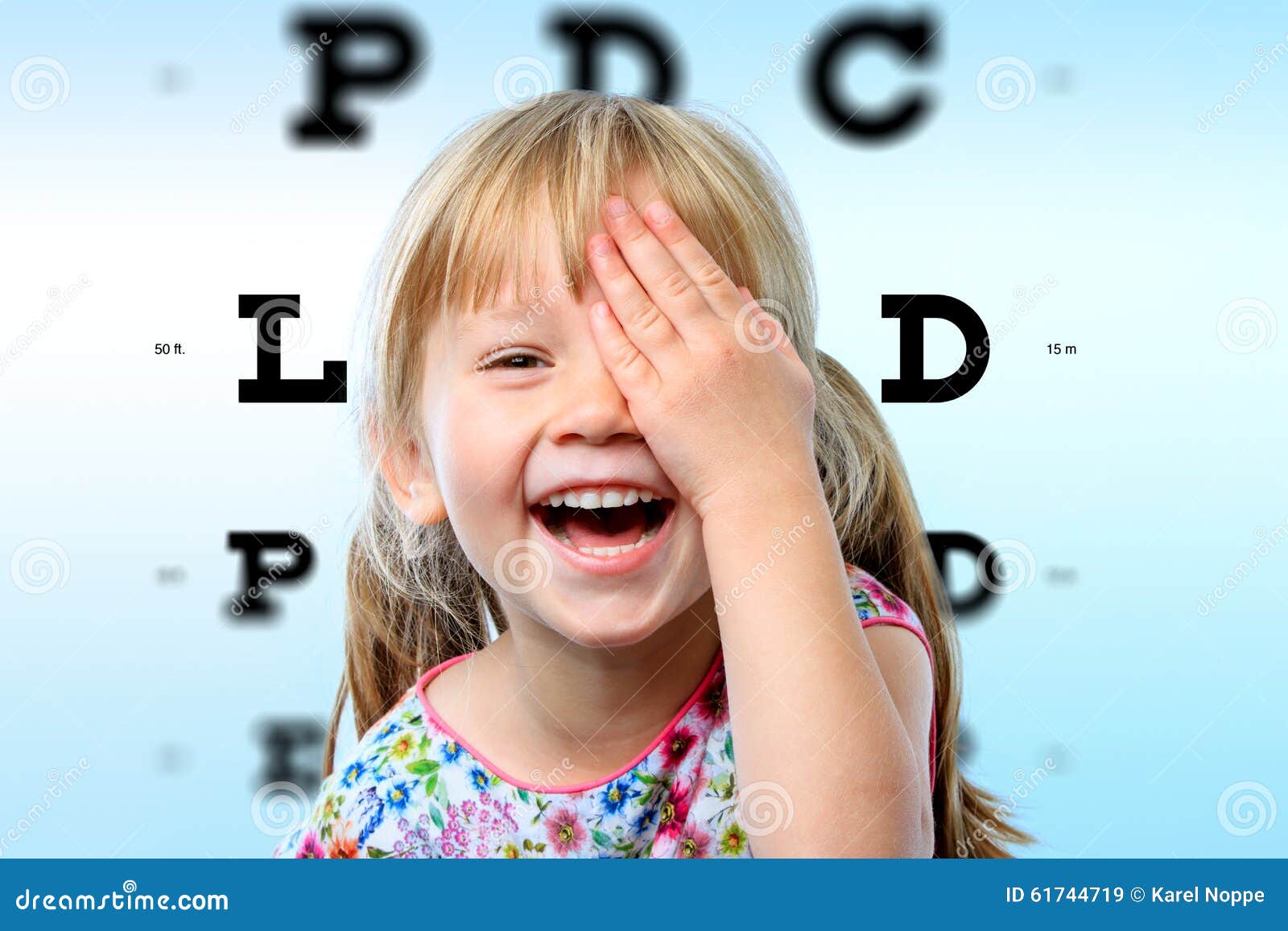 girl having fun at vision test.