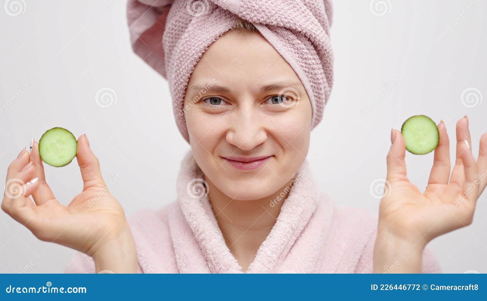 Girl with a Head Towel Wearing a Pink Bathrobe Holding Cucumber Slices ...