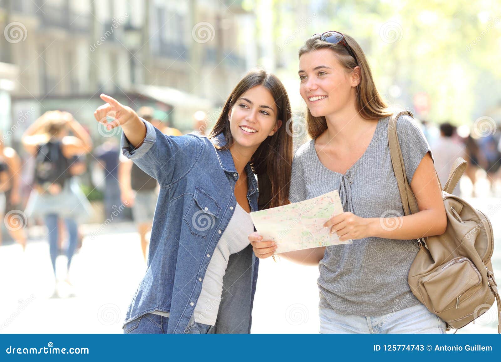 girl helping to a tourist who asks direction