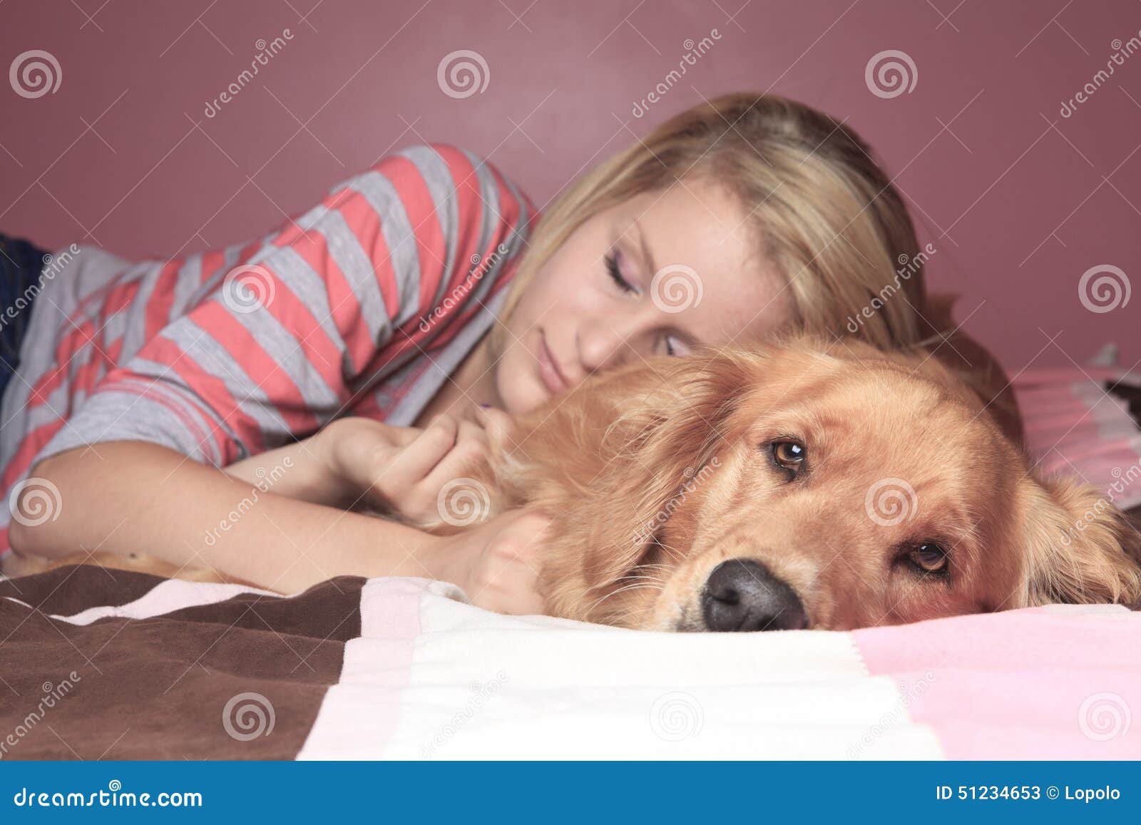 Girl And Her Dog Sleeping Together On A Bedroom Stock Image