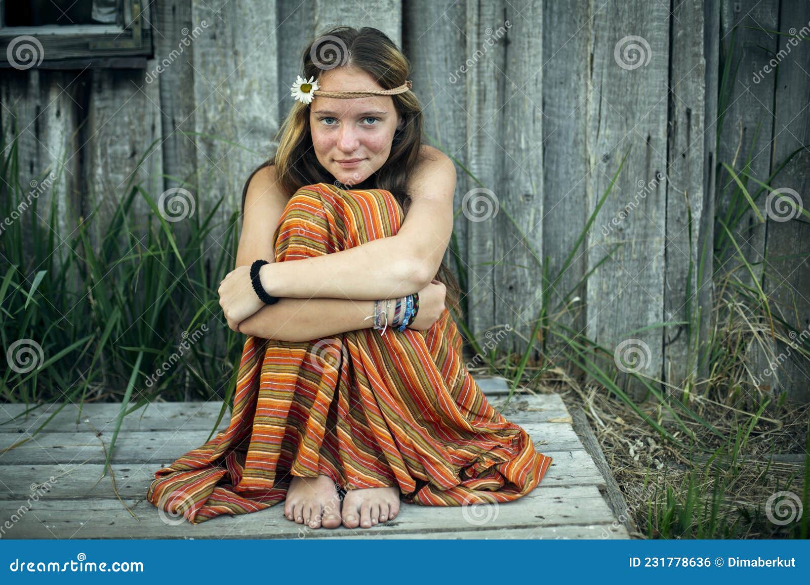 A Girl in Hippie Clothes Sitting Alone in the Village Outdoors. Stock ...