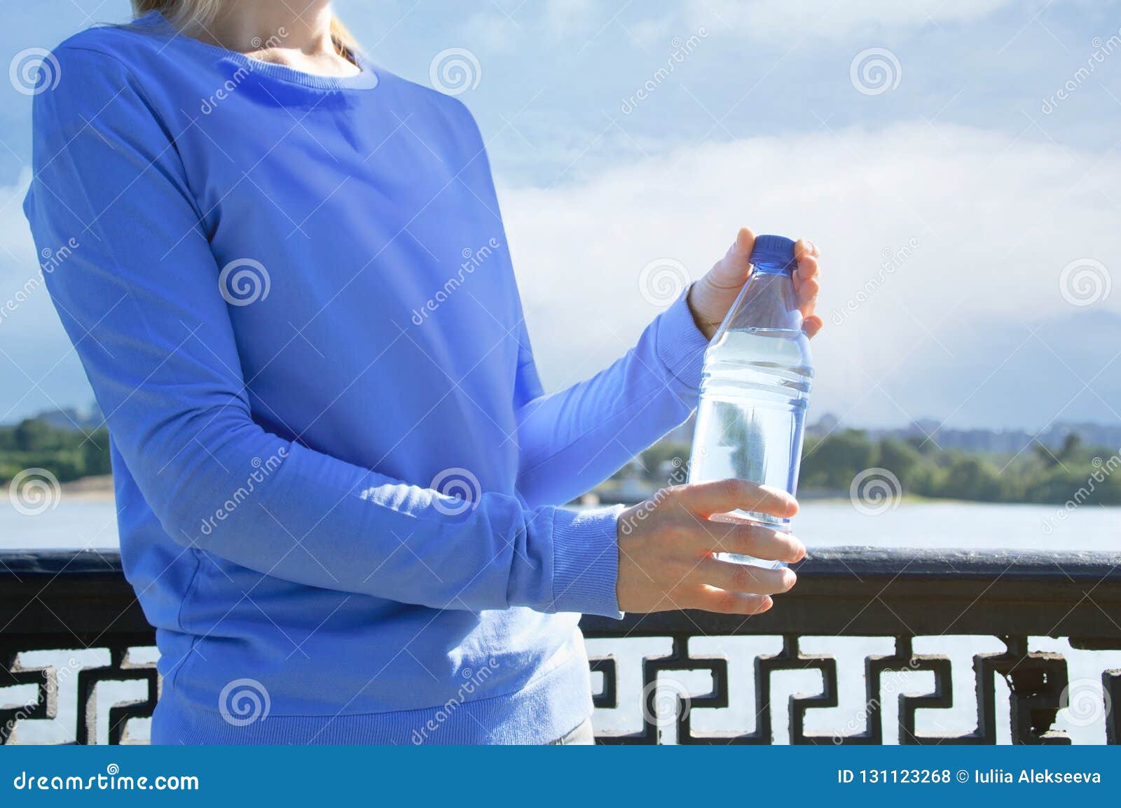 Girl is Holding a Bottle of Water. Stock Photo Image of health, hold