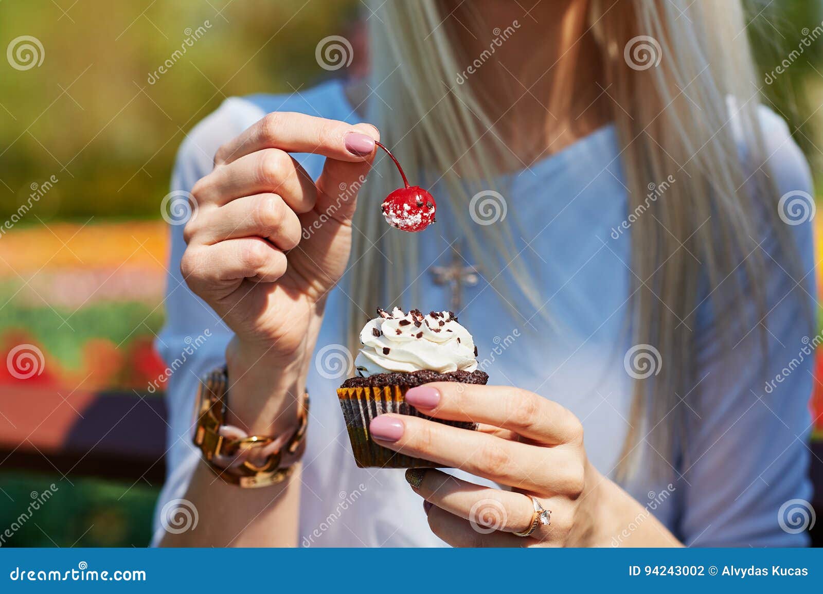 Girl holding a cupcake for stock photo. Image of frosting 94243002