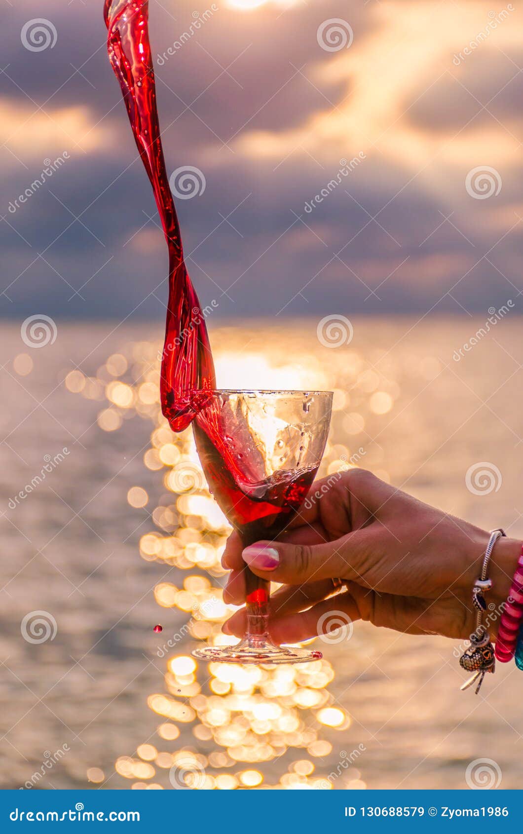 Girl Holding a Glass with Wine during the Sunset Stock Image - Image of