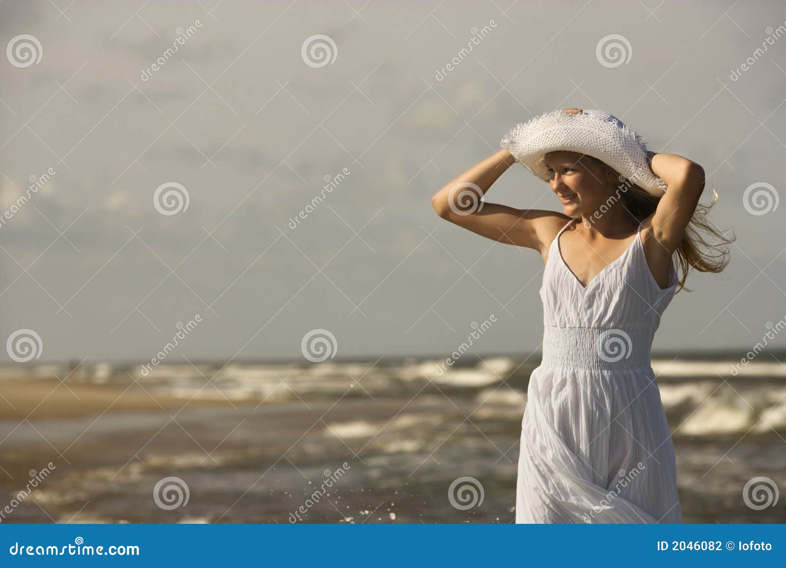 Girl holding hat at beach. stock photo. Image of carolina 2046082