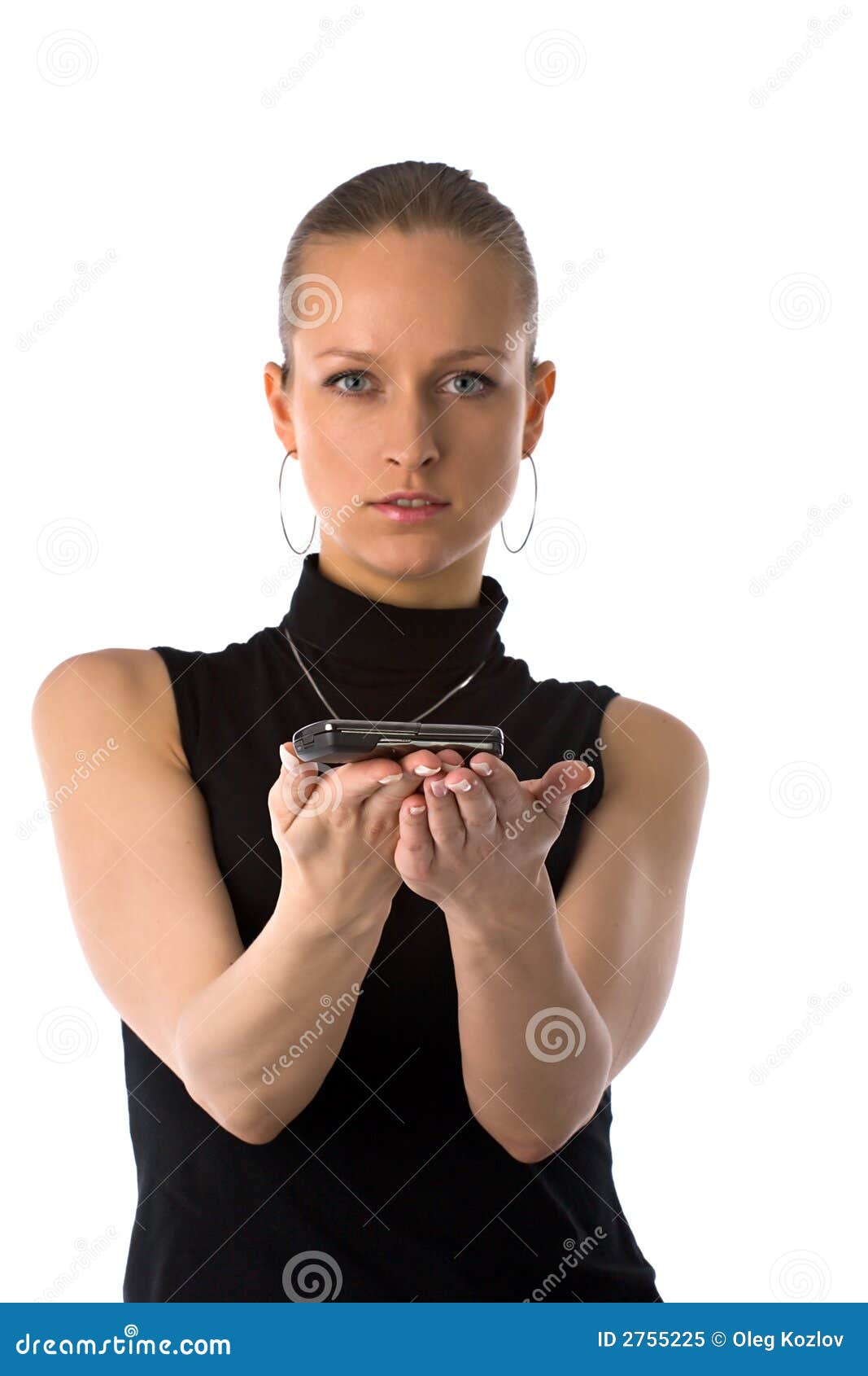 Serious beautiful girl holding mobile phone with her hands. Small DOF, focus is on hands.