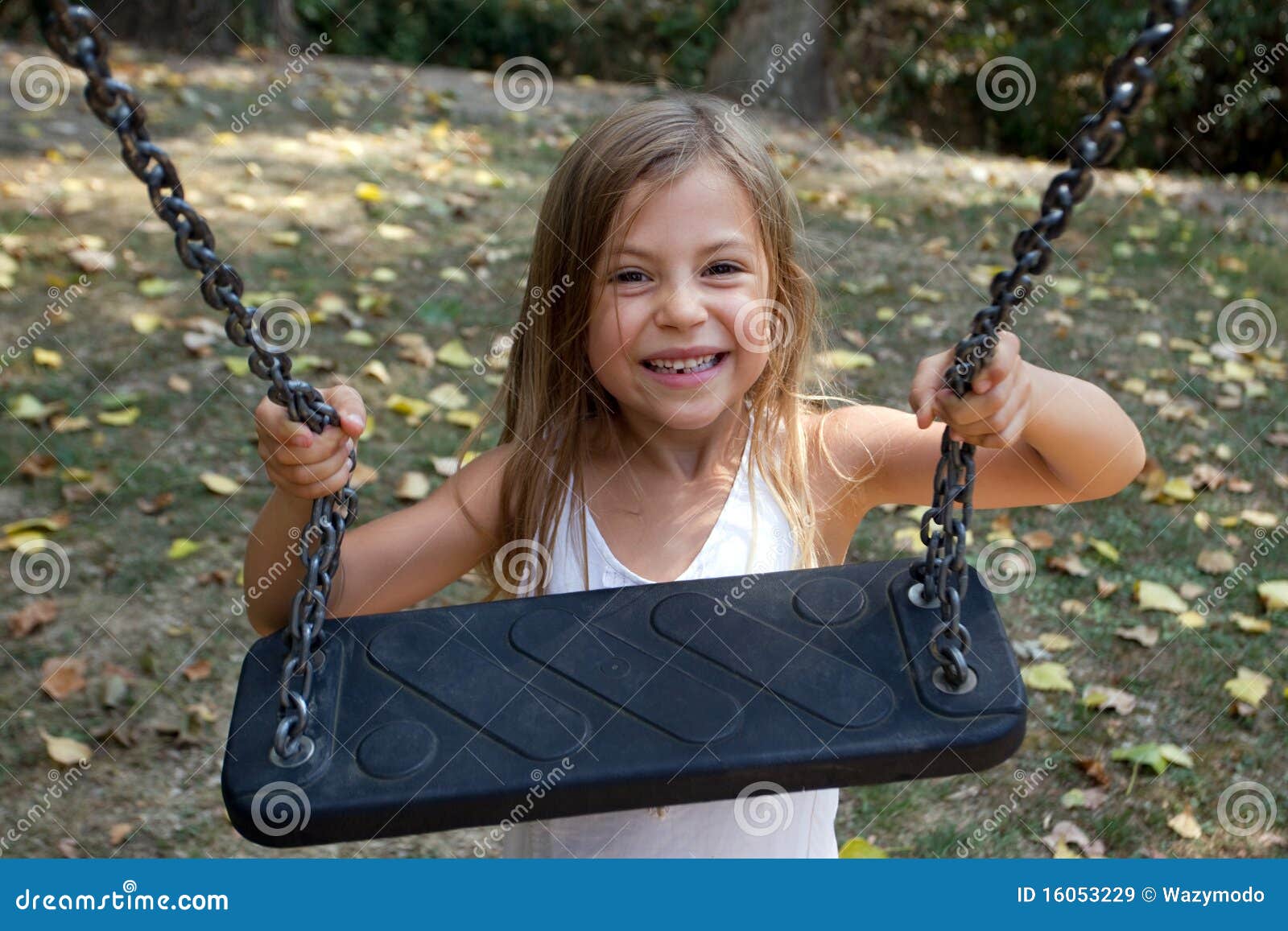 girl holding onto swing
