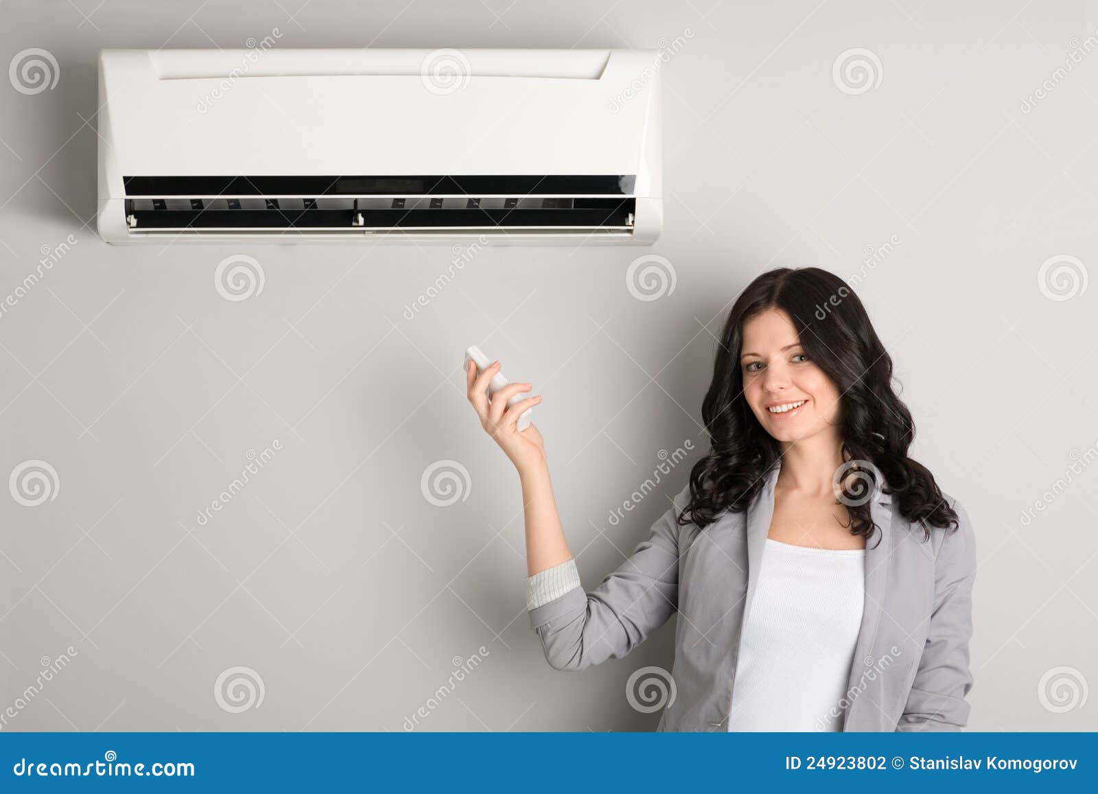 girl holding a remote control air conditioner