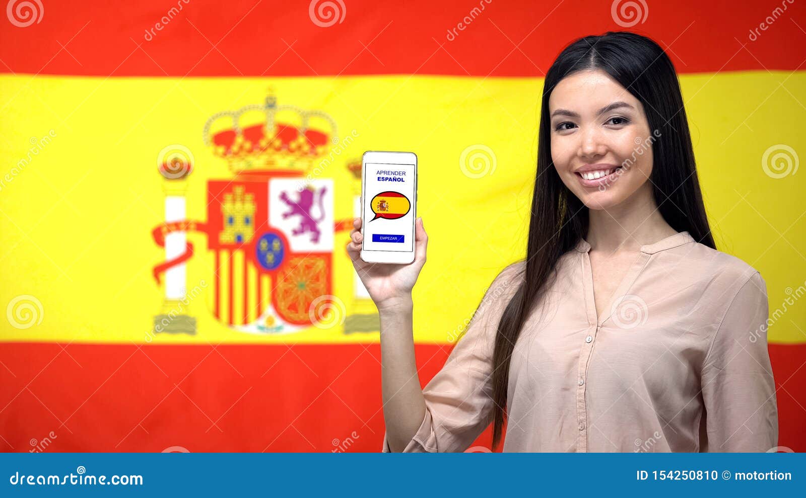 girl holding smartphone with language study app, spanish flag on background