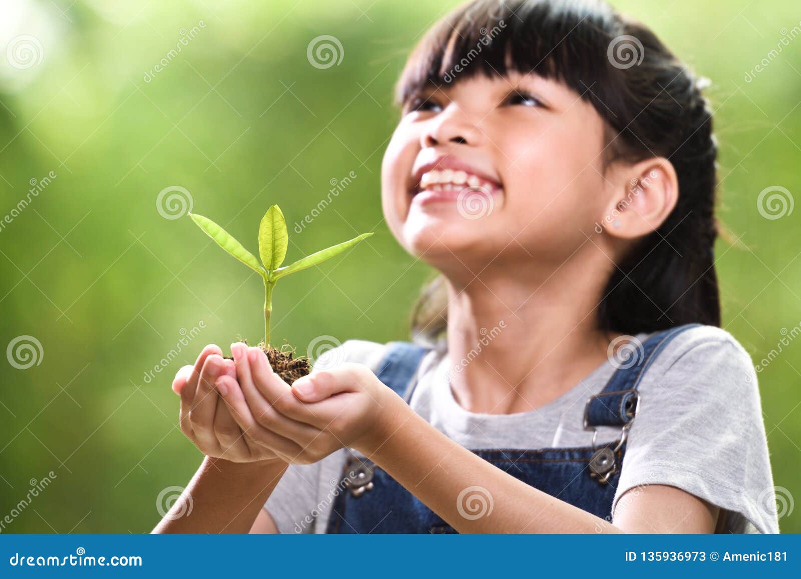 A Girl Holding a Young Plant in Her Hands with a Hope of Good