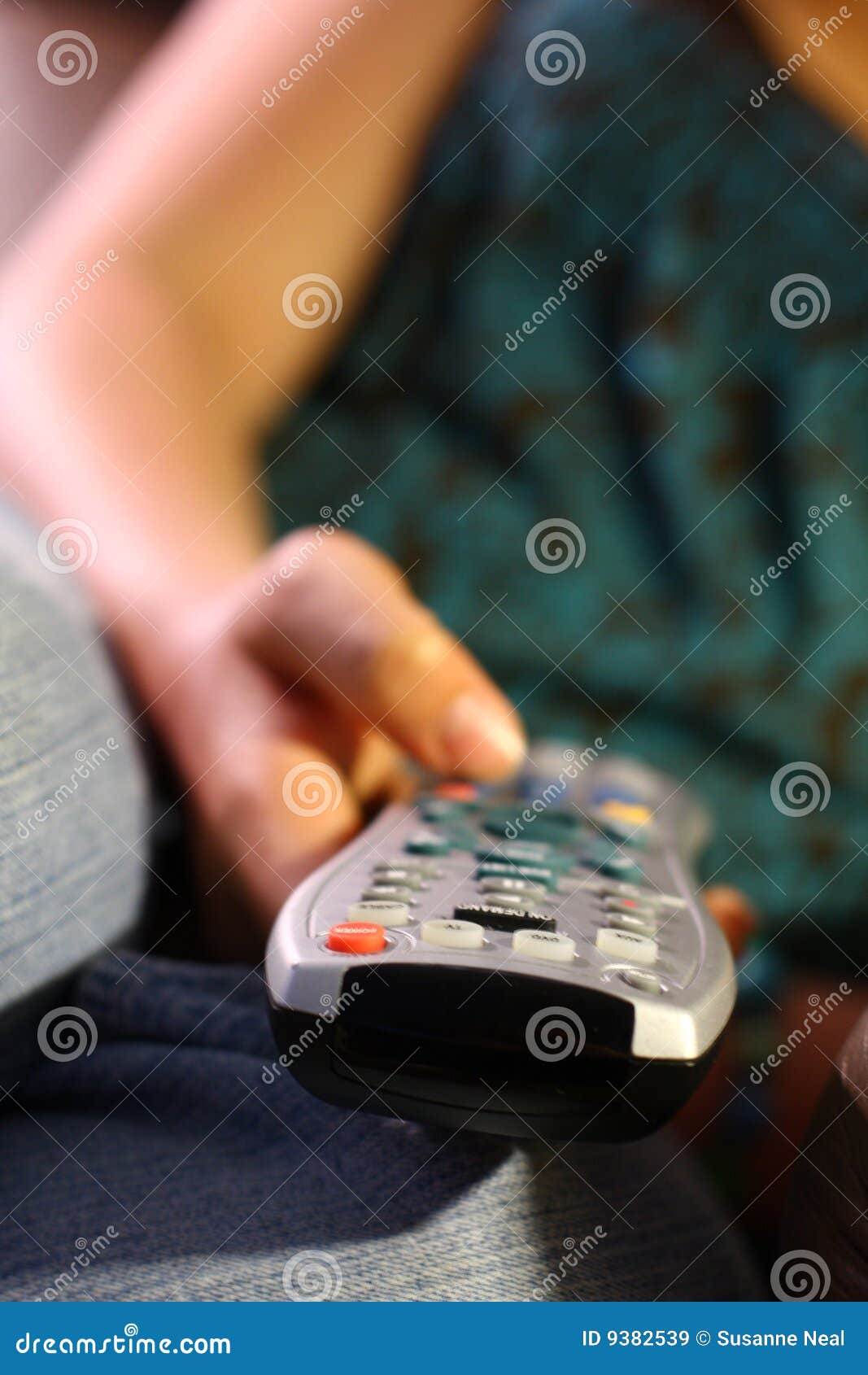 girl holds remote control for tv