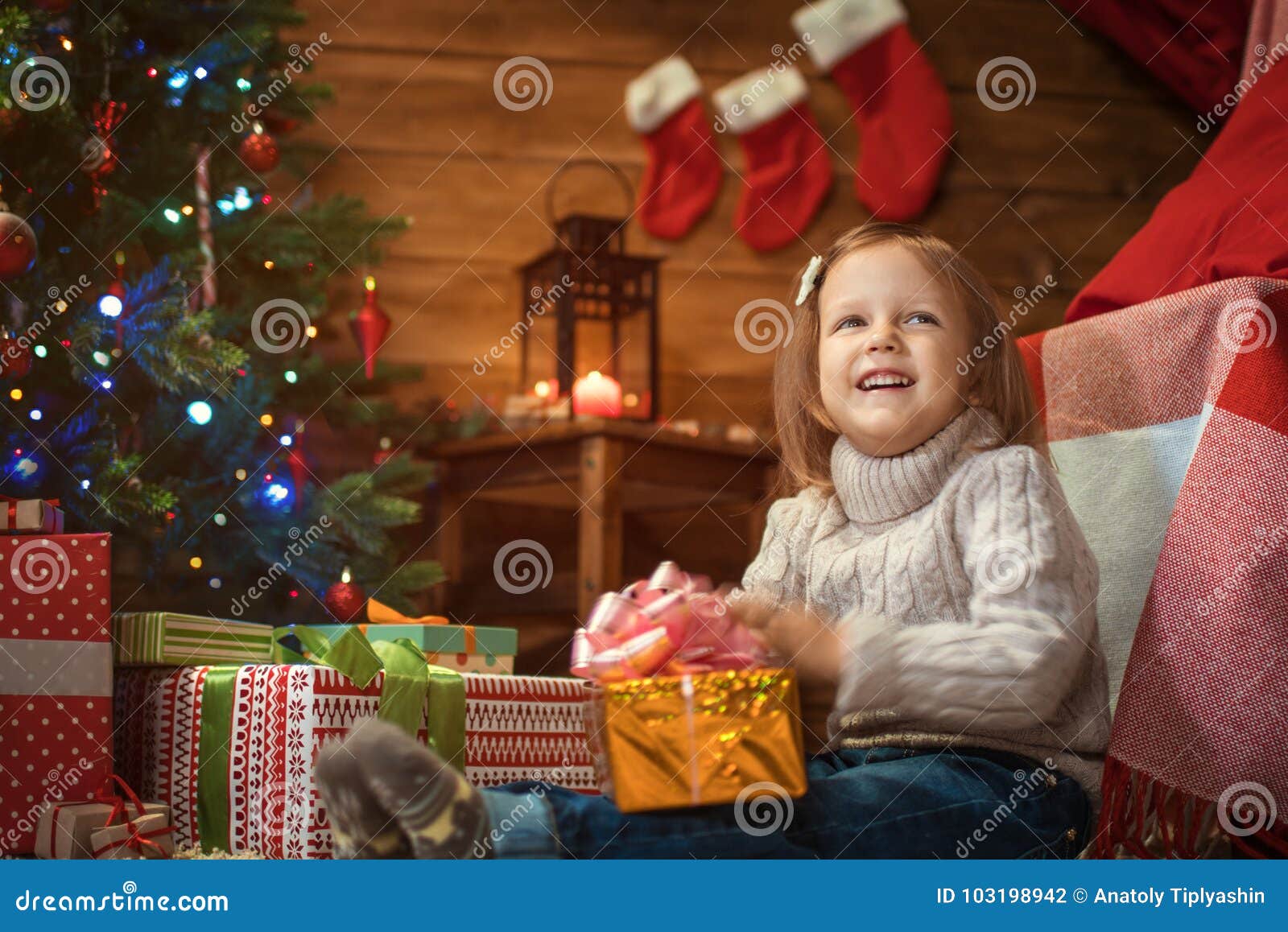 Girl at Home with a Christmas Tree, Presents and Candles Celebrating ...
