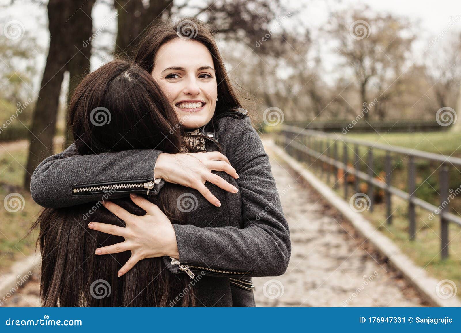 Girl Hugging Her Best Friend. in the City Park Stock Image - Image ...