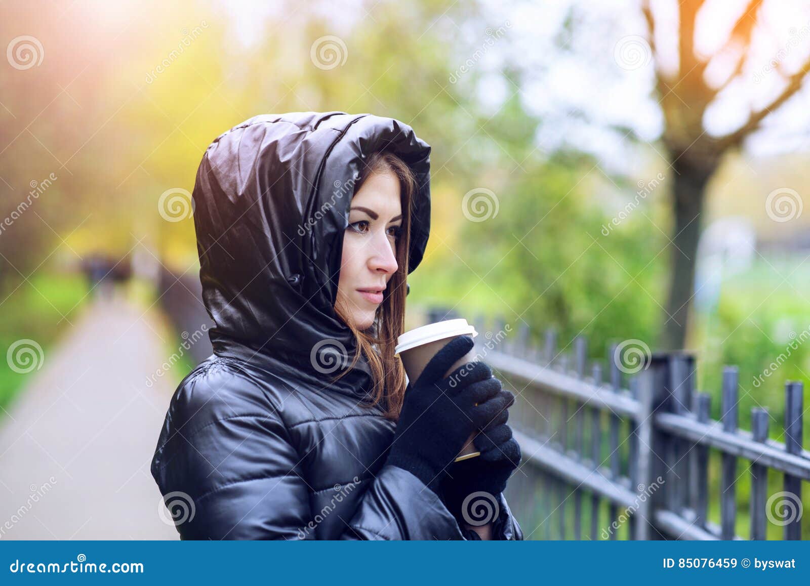 Girl in Jacket with Hood, Holding a Coffee or Tea, Young Enjoys the ...