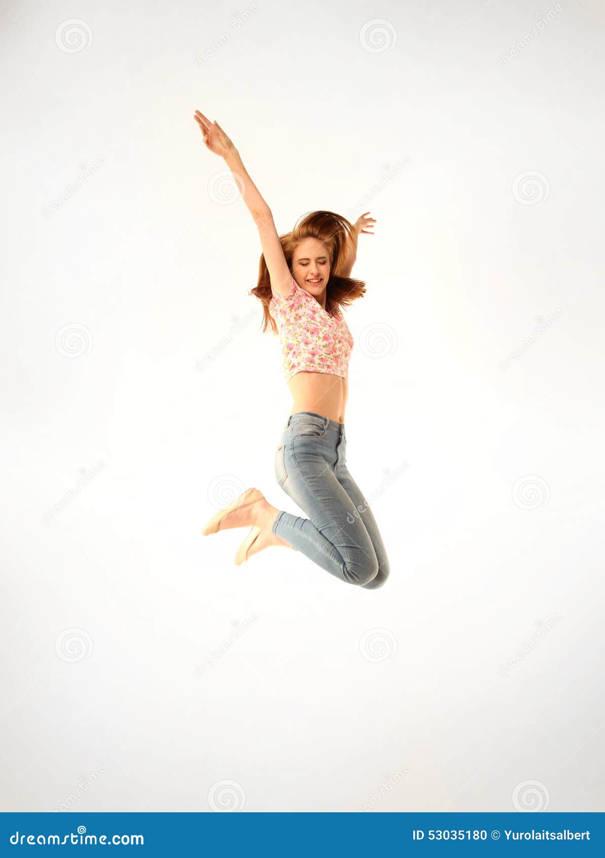 Girl with Jeans and Pink Top Jumping Energetically Stock Photo - Image ...