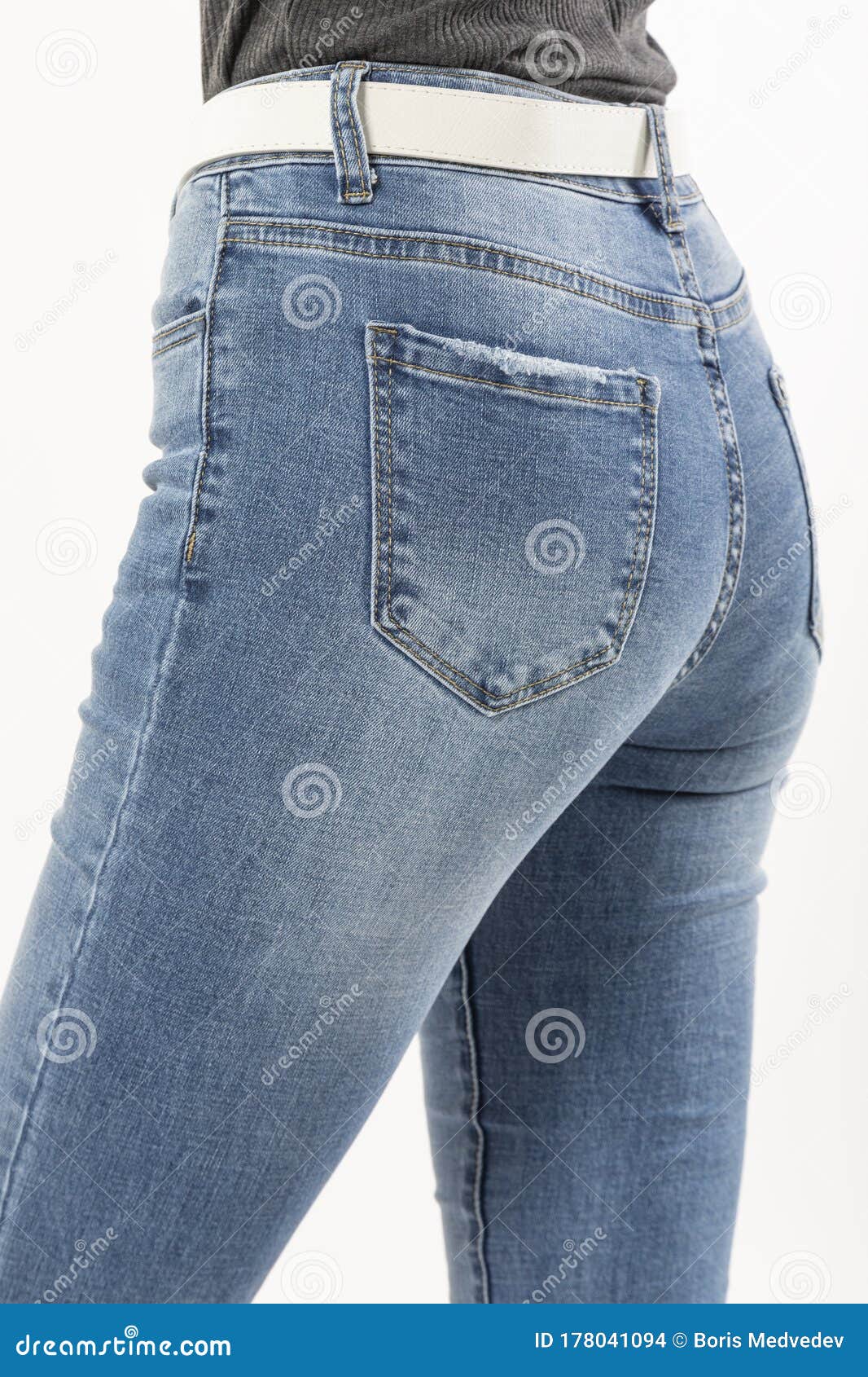 Girl in Jeans Shows Jeans Back Pockets on a White Background Close-up ...