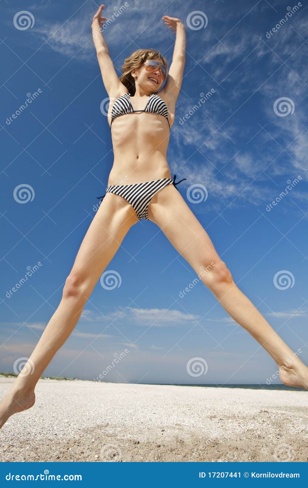 Girl jumping on a beach stock image. Image of bikini - 17207441