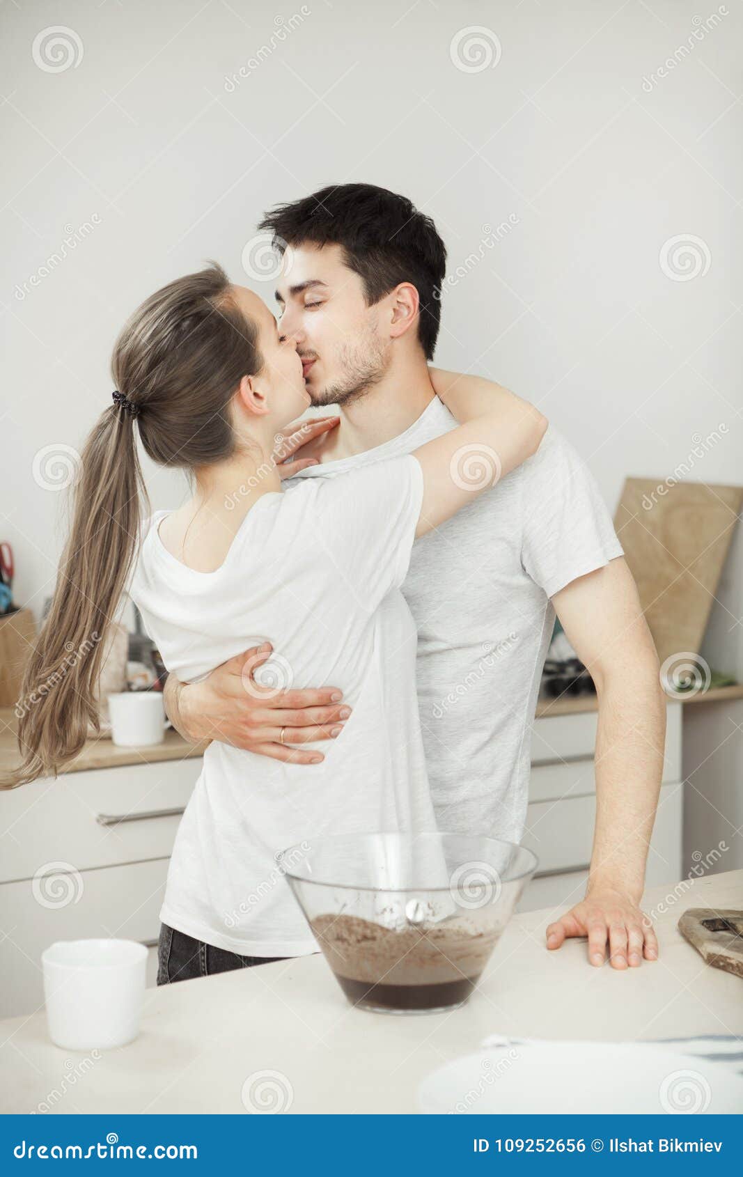 Girl Kisses Her Adorable Husband in the Kitchen. Romantic Couple ...