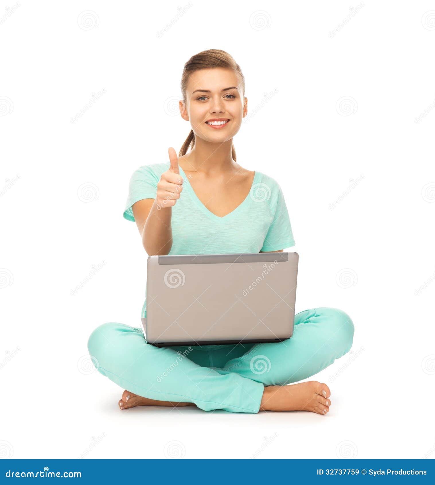 Girl with laptop showing thumbs up. Young girl sitting on the floor with laptop showing thumbs up