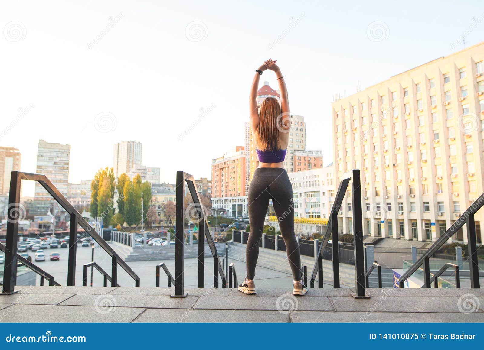 Girl in Leggings and Tops is Playing Sports in the Background of a ...