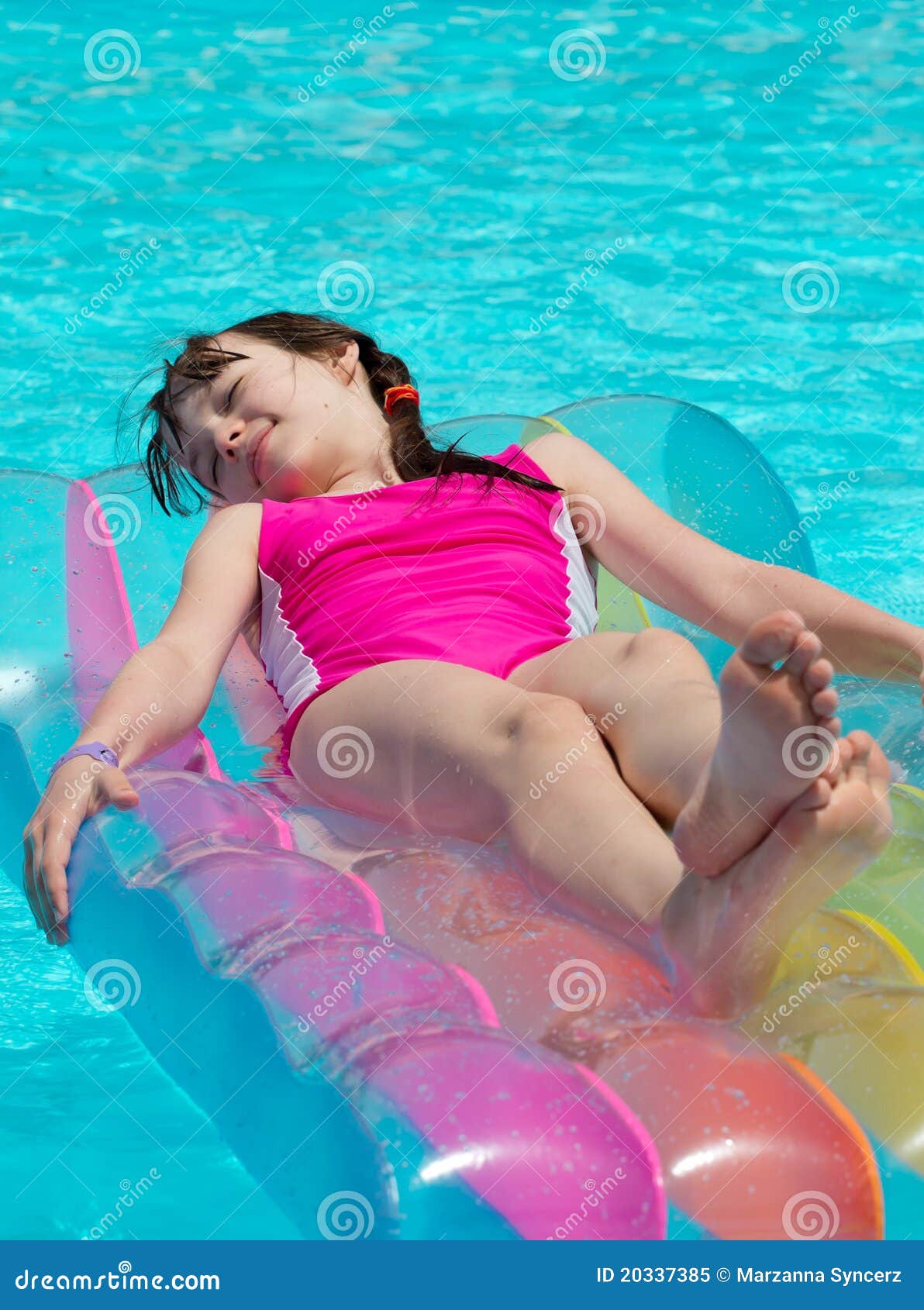 girl on lilo in swimming pool