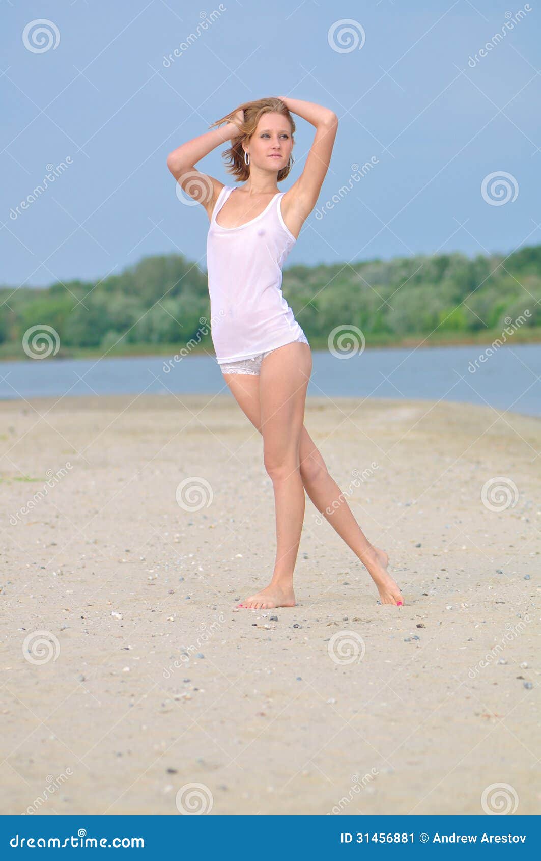 Girl in Lingerie Walking Along the Sandy Beach Stock Image