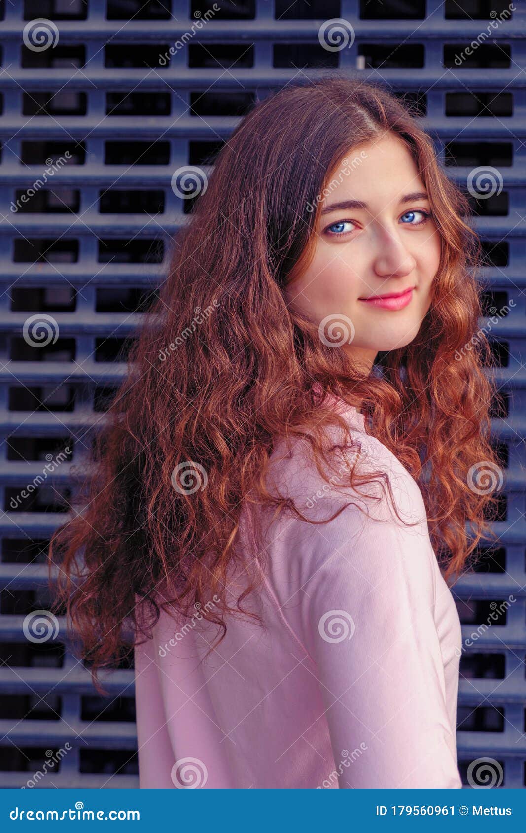 The Girl with Long Curly Brown Hair Turns To the Camera and Looks Straight  Ahead. she Stands in Front of an Iron Grating Stock Image - Image of  outdoor, lifestyle: 179560961
