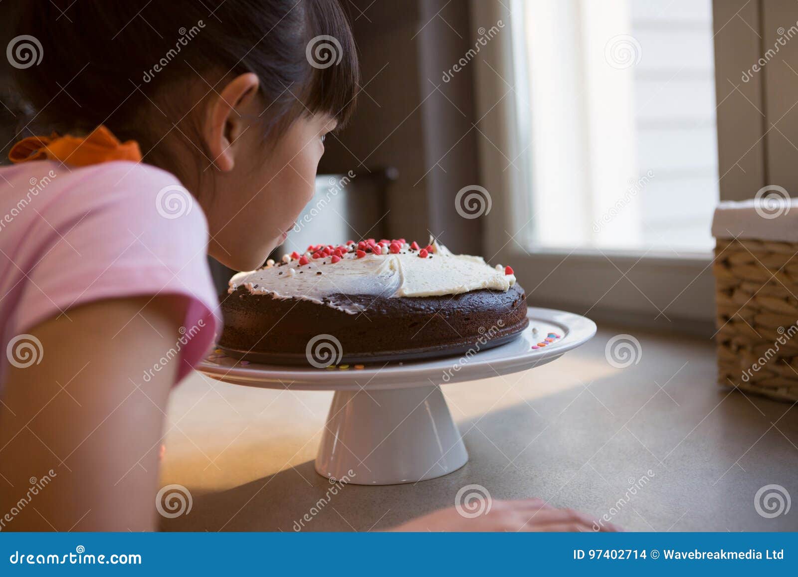 Girl looking at cake stock photo. Image of girl, child 97402714