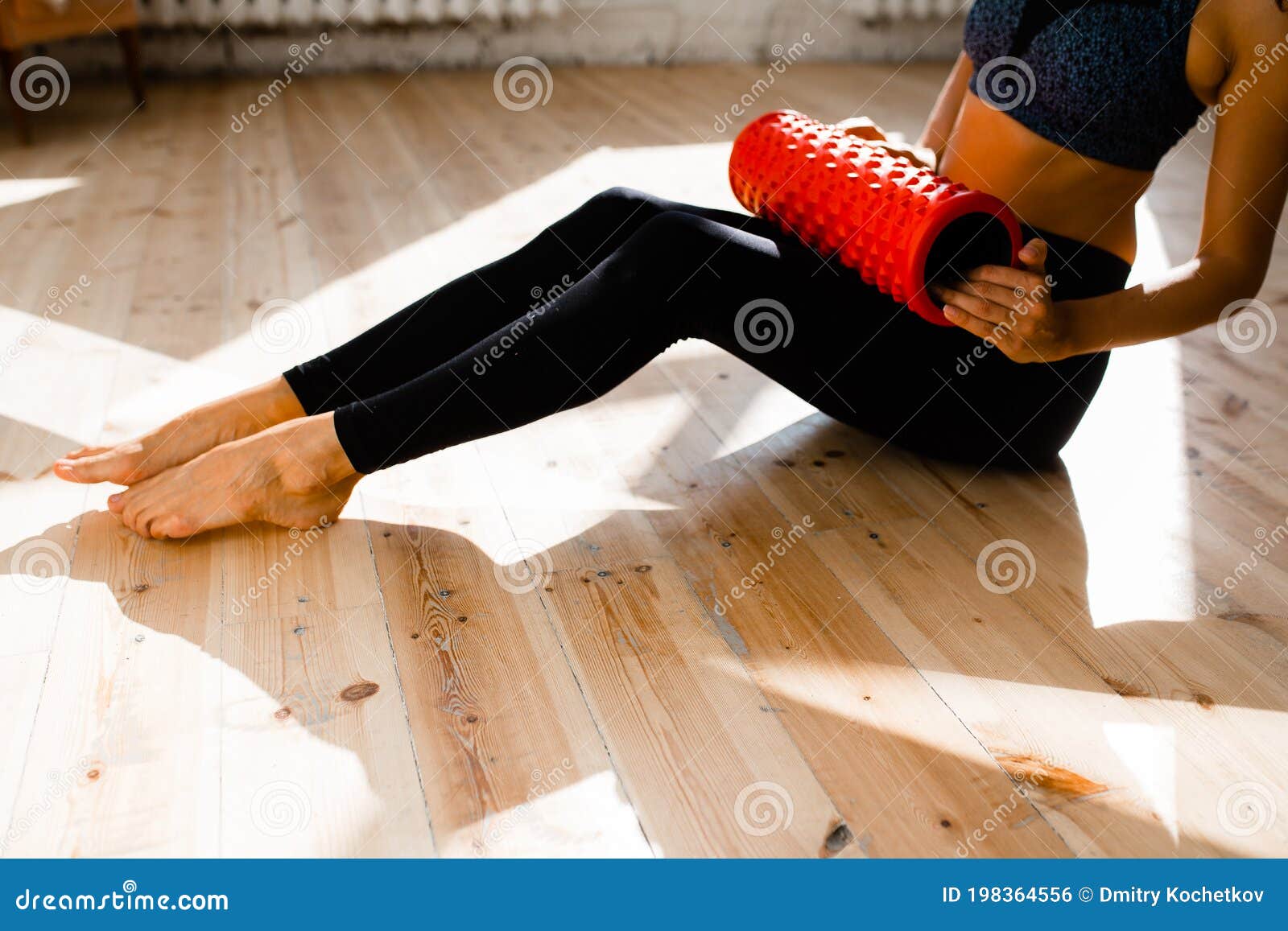 The Girl Makes Massage of the Front Surface of the Thigh after Training