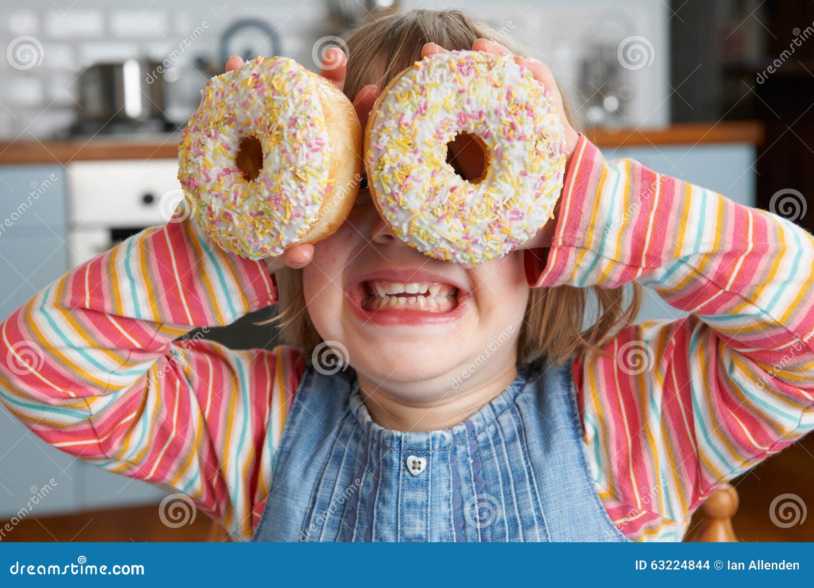 girl making glasses using sugary doughnuts